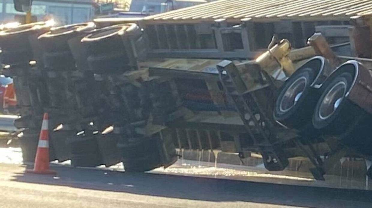 A truck has rolled on a road in Auckland, spilling glue.