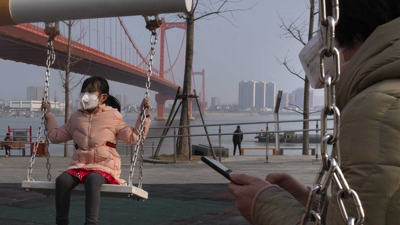 A child plays in the middle of Wuhan, the city effectively besieged as a consequence of the coronavirus plague.