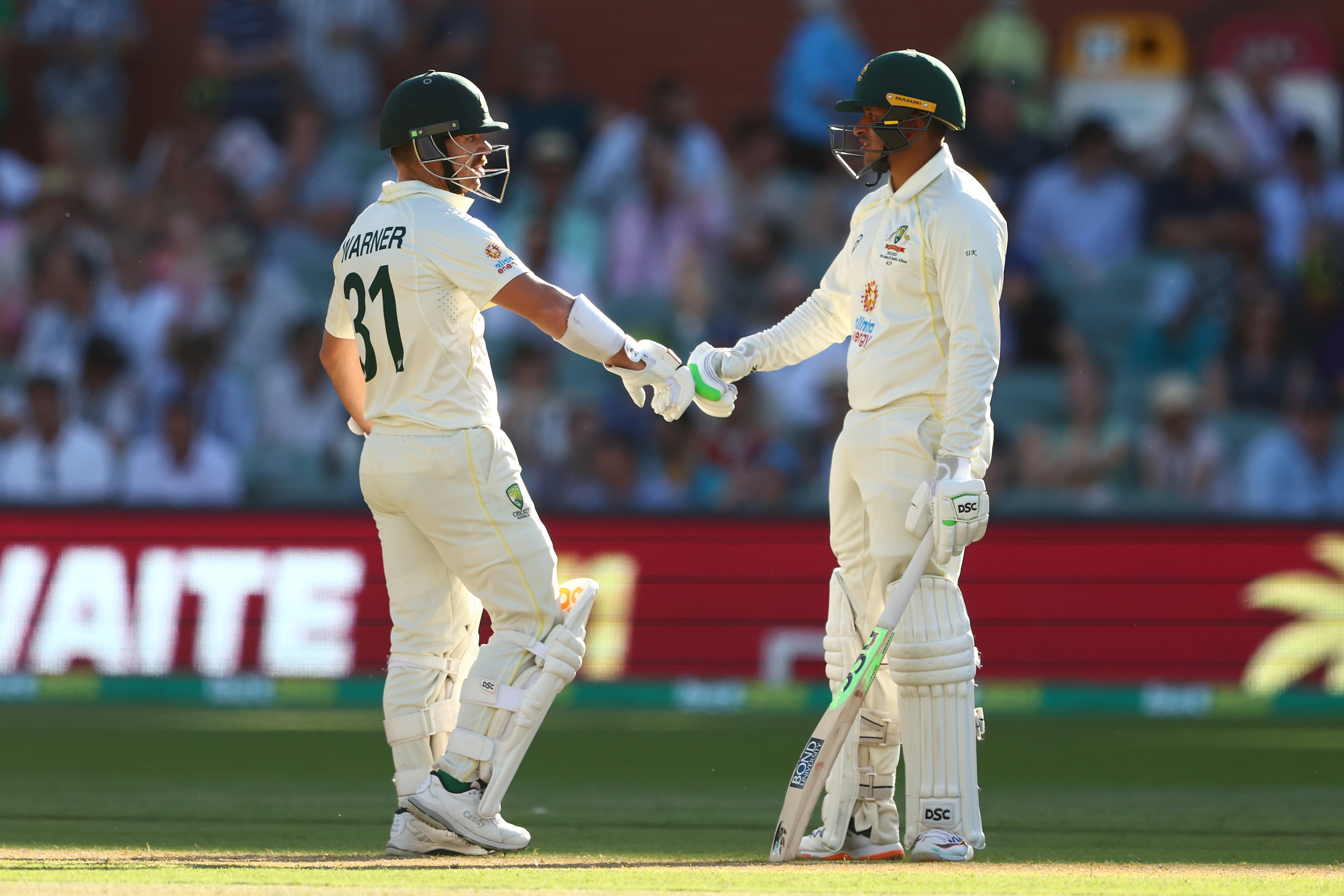 David Warner and Usman Khawaja of Australia speak between the wickets during day three of the Second Test Match in the series between Australia and the West Indies at Adelaide Oval on December 10, 2022 in Adelaide, Australia. (Photo by Chris Hyde/Getty Images)