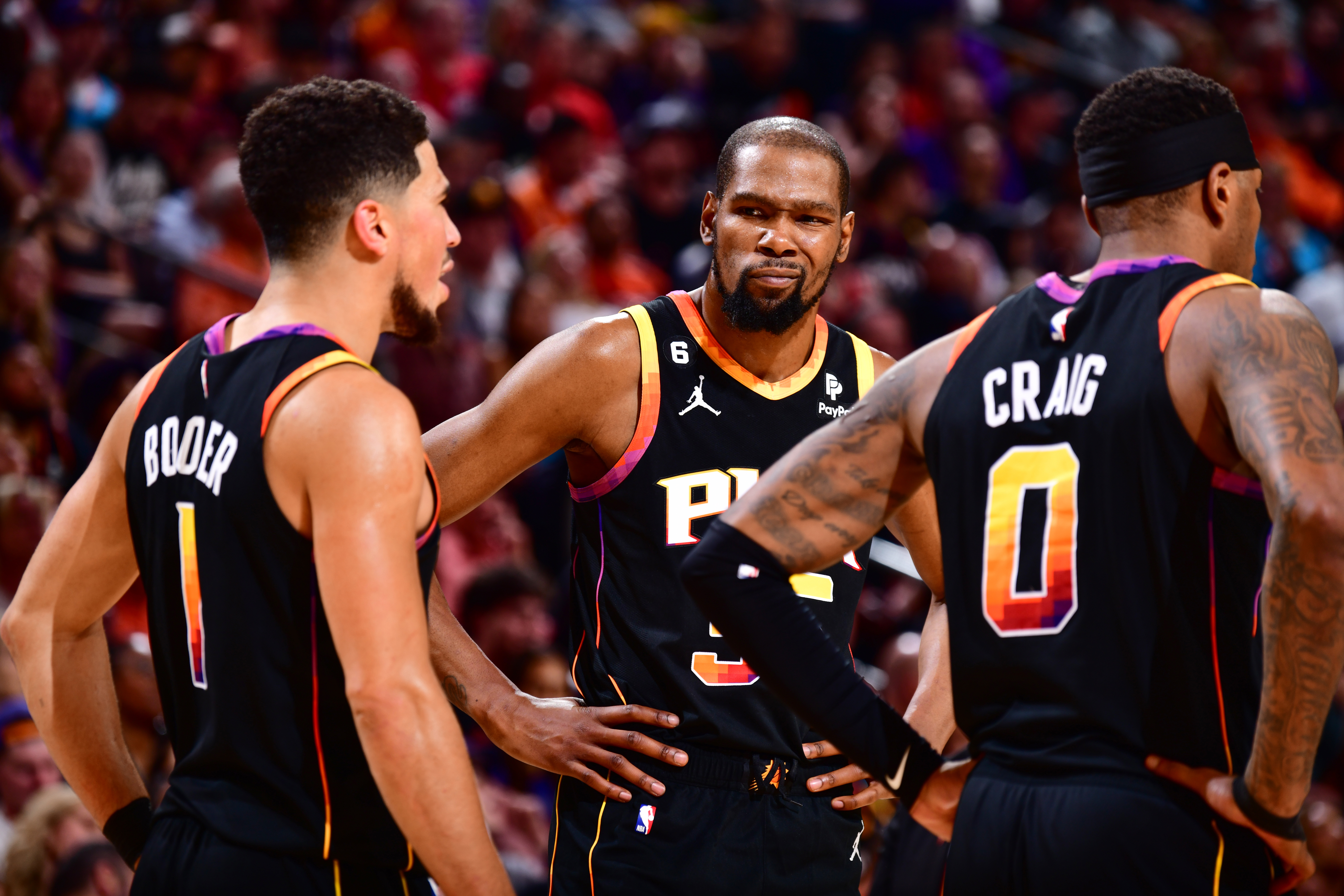 PHOENIX, AZ - APRIL 16: Devin Booker #1, Torrey Craig #0, & Kevin Durant #35 of the Phoenix Suns looks on during the game During round one game one of the 2023 NBA Playoffs on April 16, 2023 at Footprint Center in Phoenix, Arizona. NOTE TO USER: User expressly acknowledges and agrees that, by downloading and or using this photograph, user is consenting to the terms and conditions of the Getty Images License Agreement. Mandatory Copyright Notice: Copyright 2023 NBAE (Photo by Barry Gossage/NBAE 