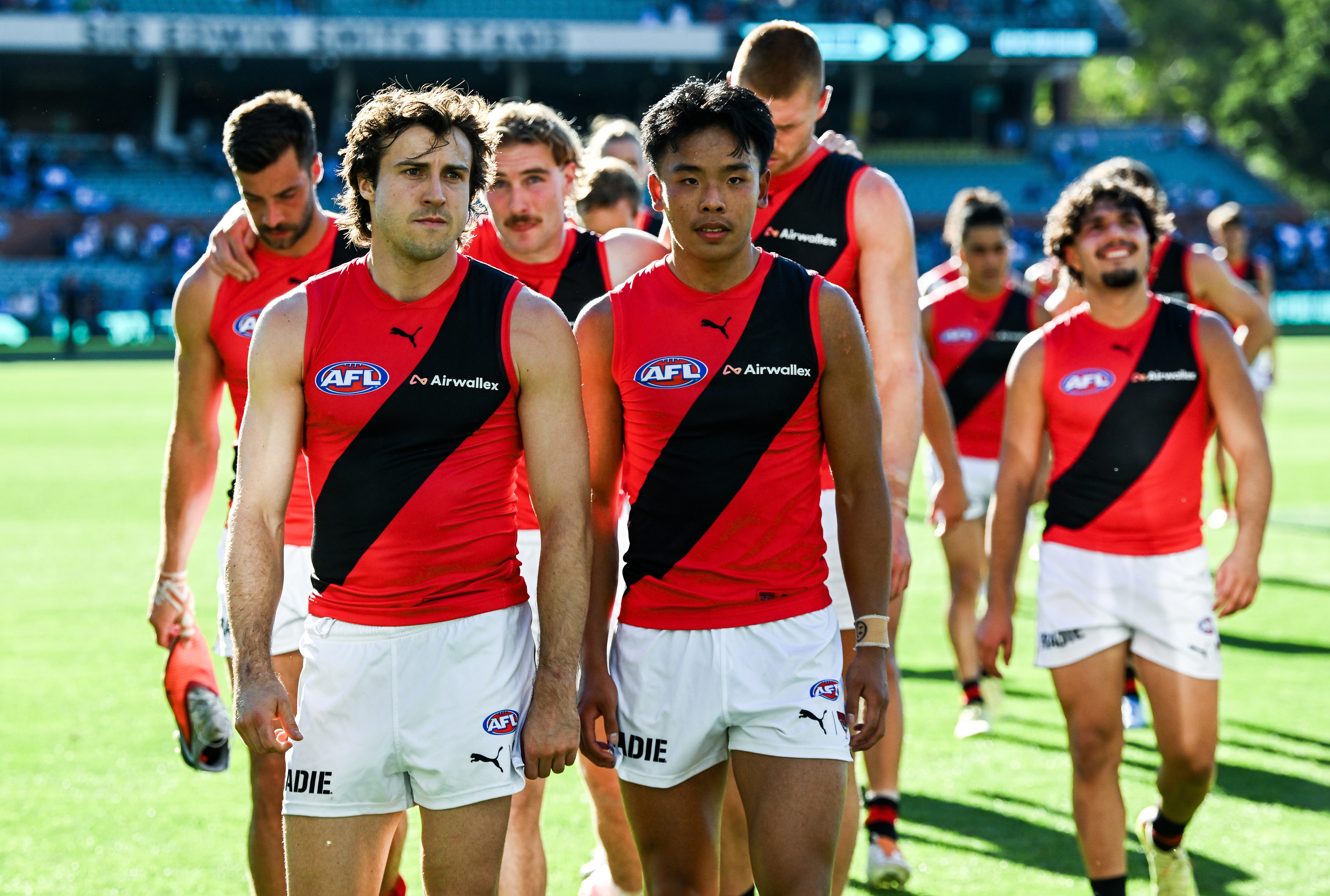 Andrew McGrath of the Bombers leads his team off after the loss to Port.