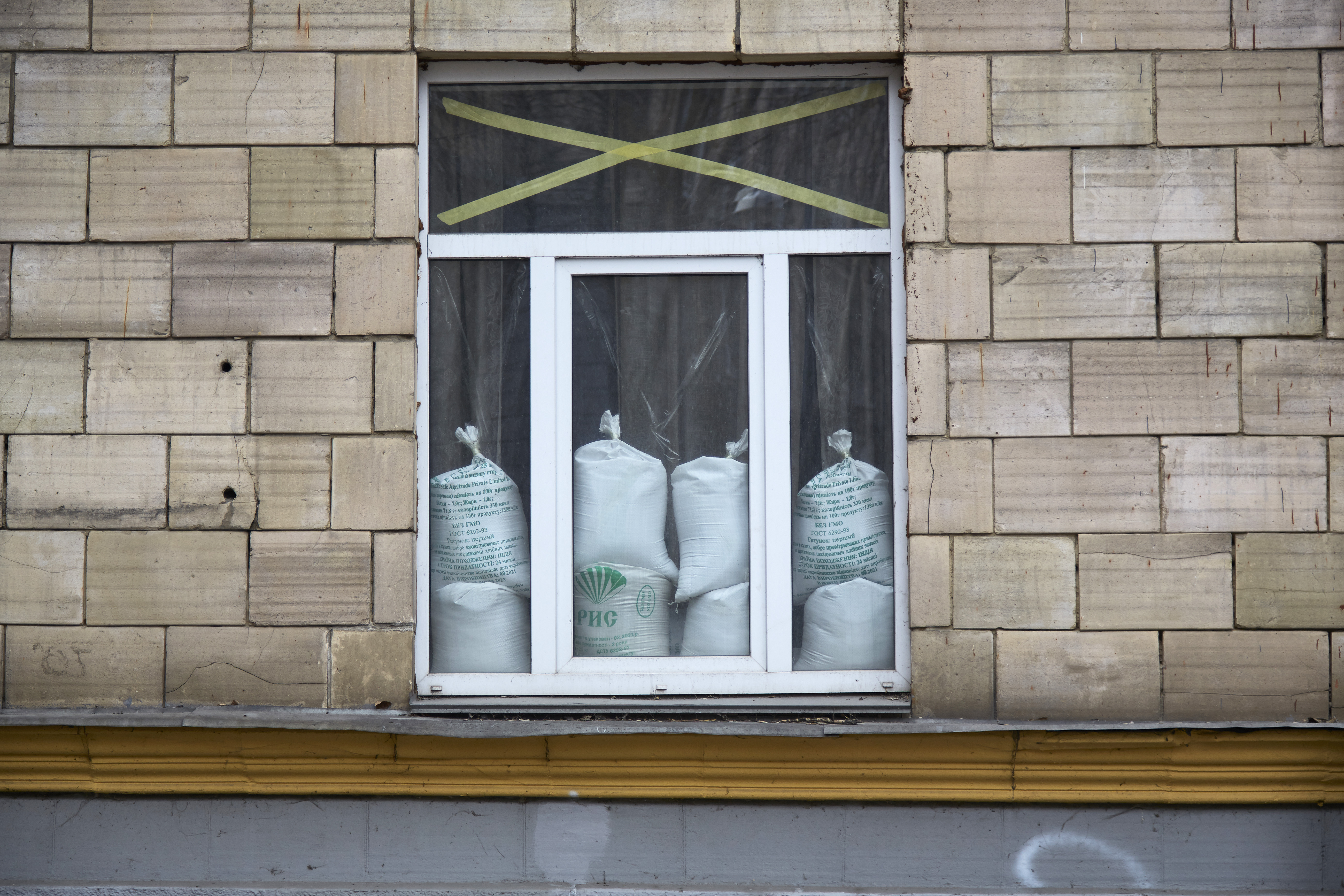 A window is protected with tape and sandbags against explosions in Kyiv, Ukraine. 