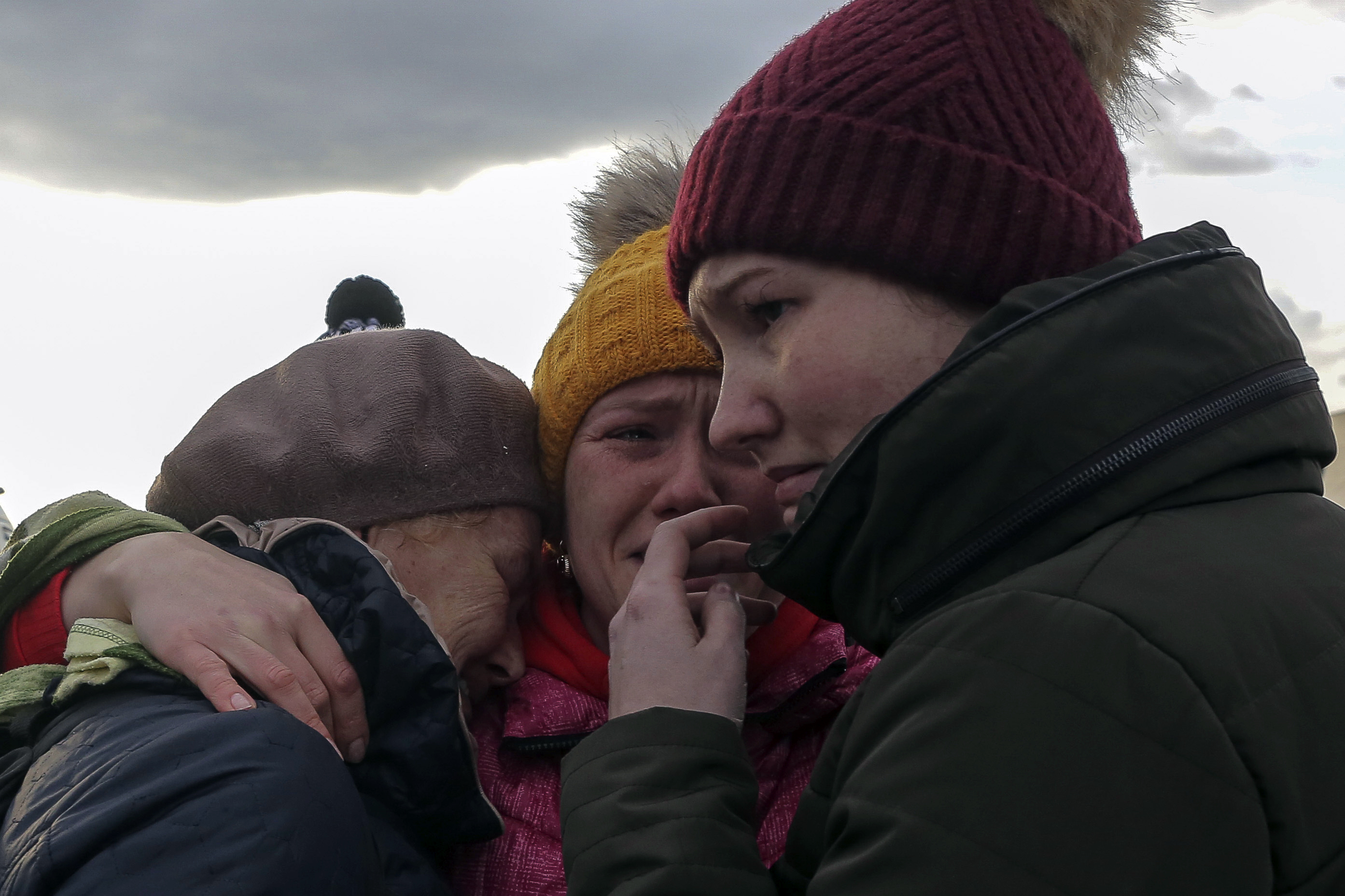 Ukranian refugees cry as they reunite at the Medyka border crossing, Poland, Saturday, Feb. 26, 2022. (AP Photo/Visar Kryeziu)