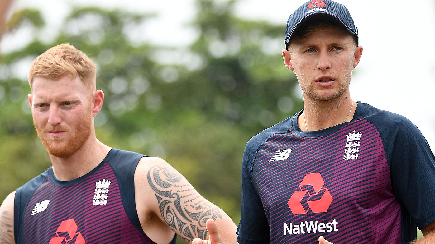 England captain Joe Root speaks to his team alongside Ben Stokes