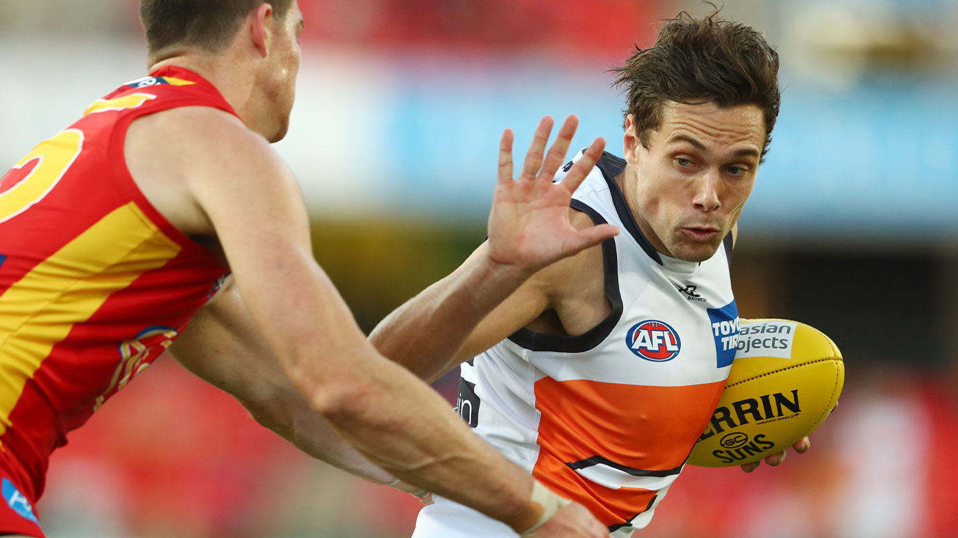 Josh Kelly of the Giants runs the ball during the round nine AFL match between Gold Coast Suns and the Greater Western Sydney Giants at Metricon Stadium on August 02, 2020