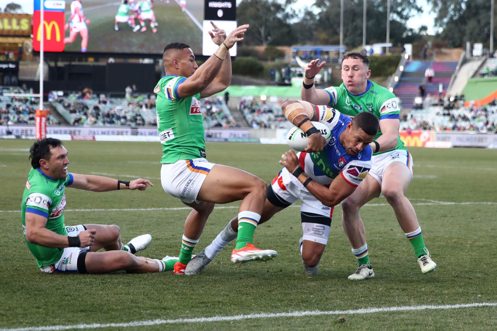 Dane Gagai breaks a tackle to score a try.