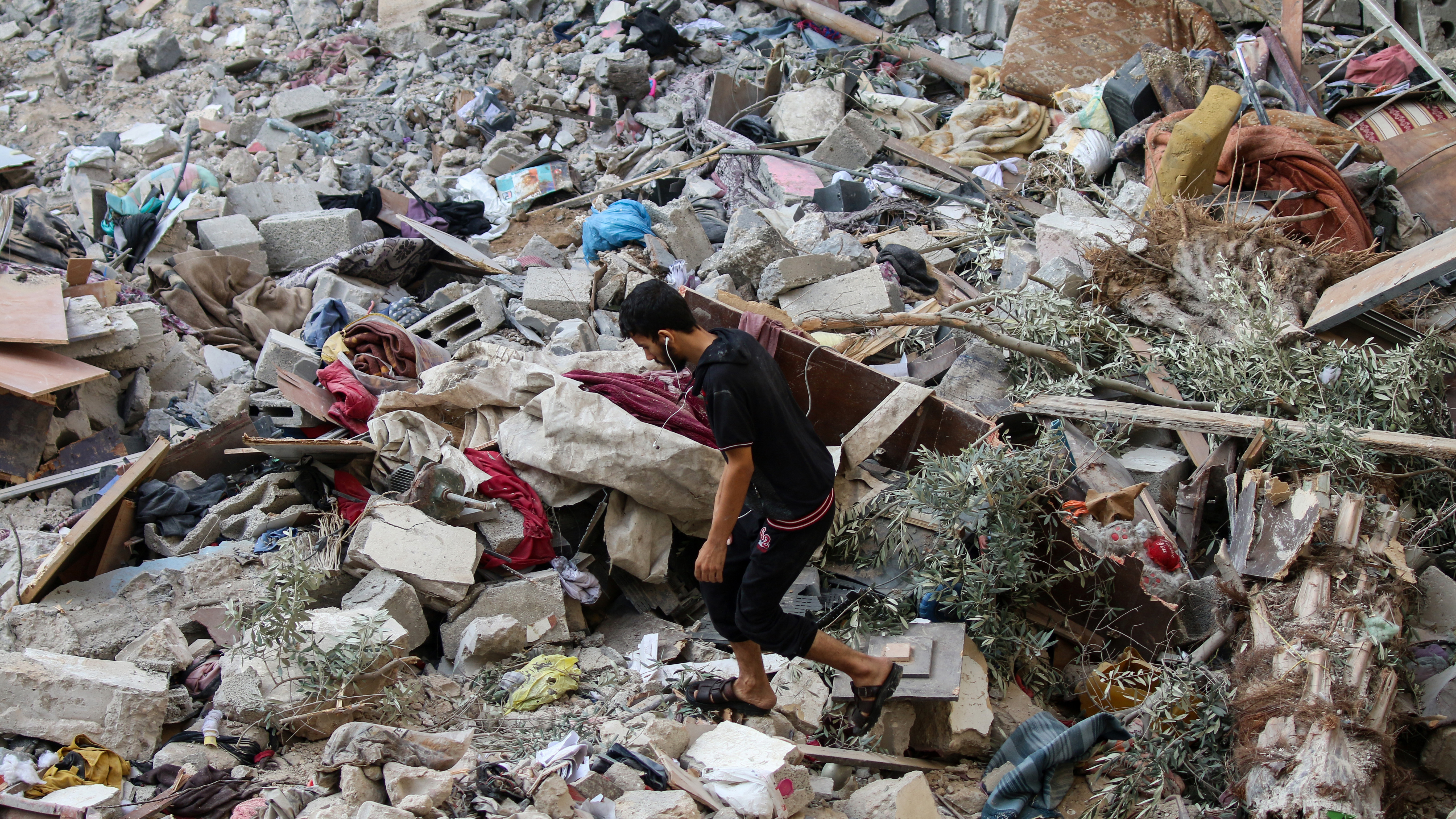 Palestinian citizens inspect damage caused by Israeli air strikes on their homes in Gaza City, Gaza.