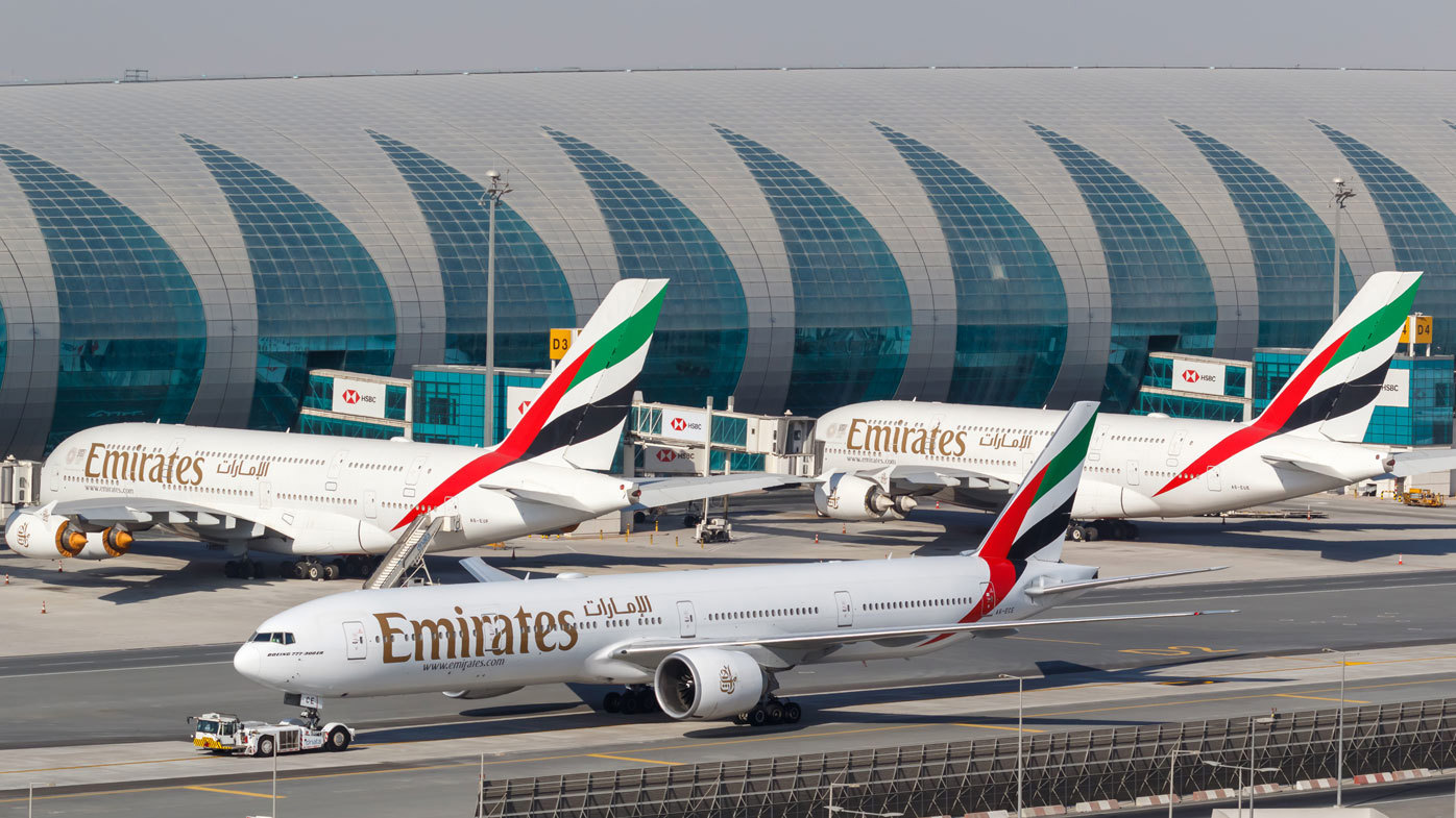 Emirates planes taxi at Dubai airport.
