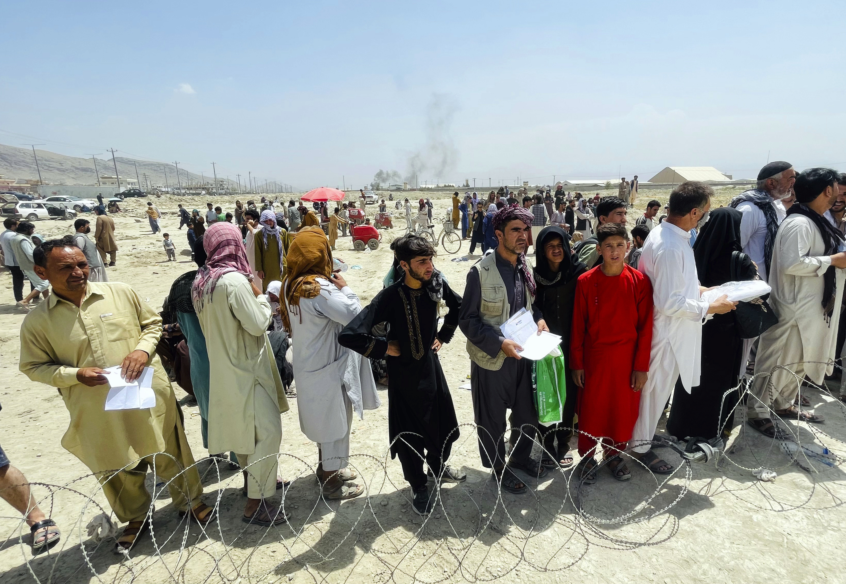 In this August 17 file photo hundreds of people gather outside the international airport in Kabul, Afghanistan. 