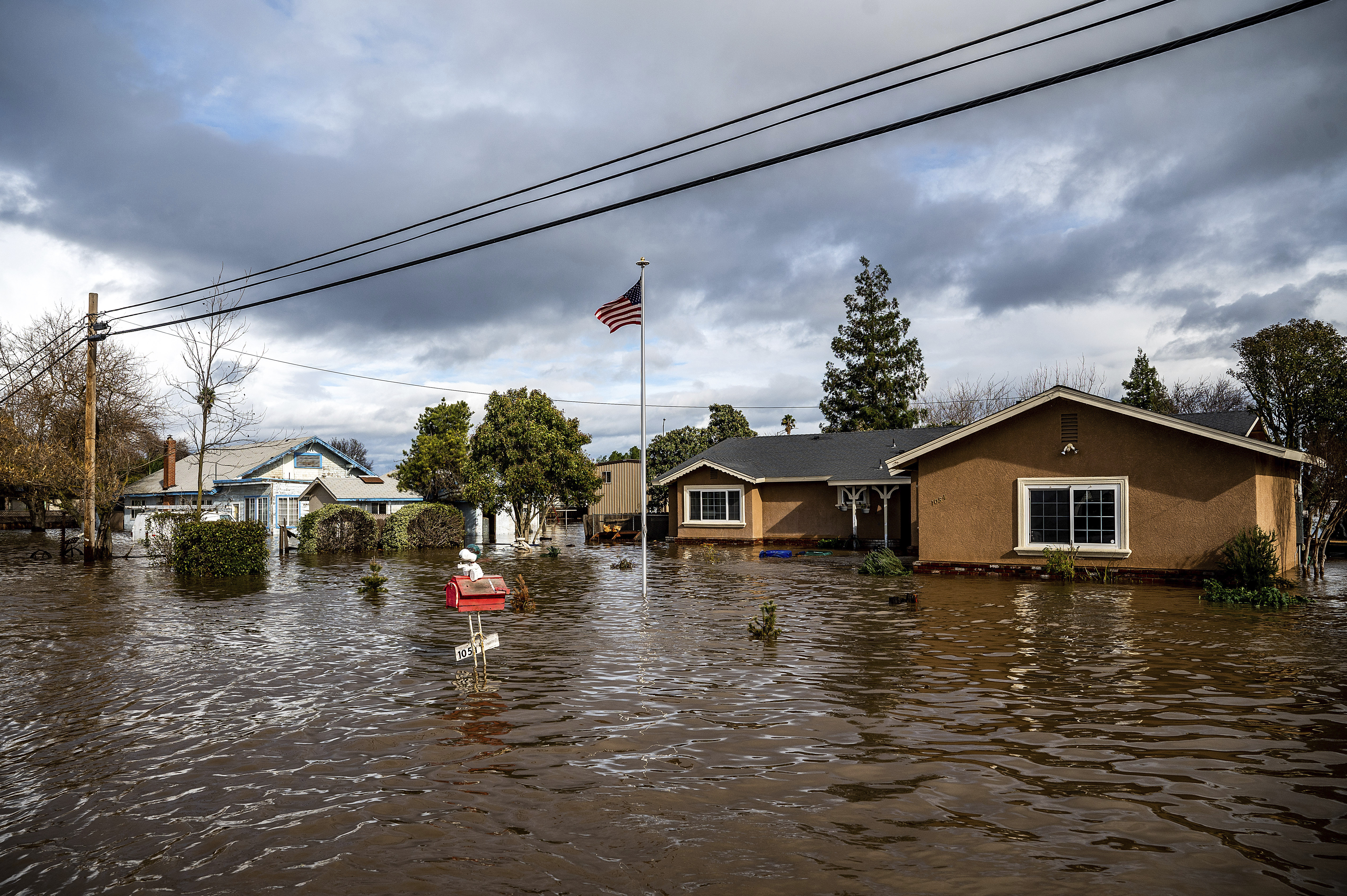 Floodwaters surround homes on Thornton Rd. in Merced, Calif., as storms continue battering the state on Tuesday, Jan. 10, 2023.