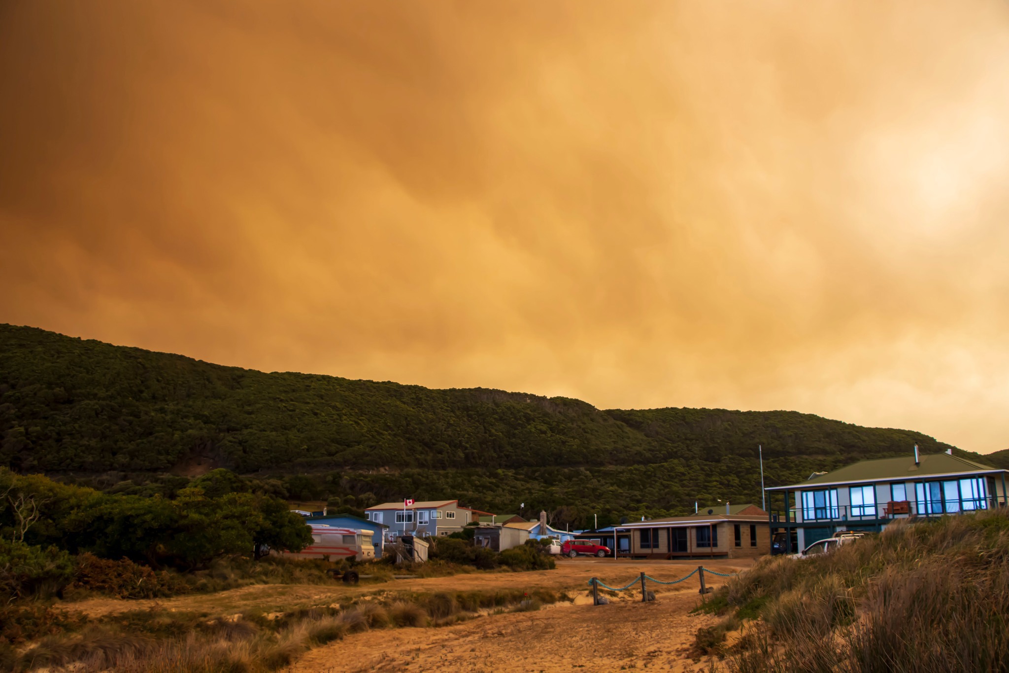 Smoke swirls in the sky at Trial Harbour from nearby bushfires. 