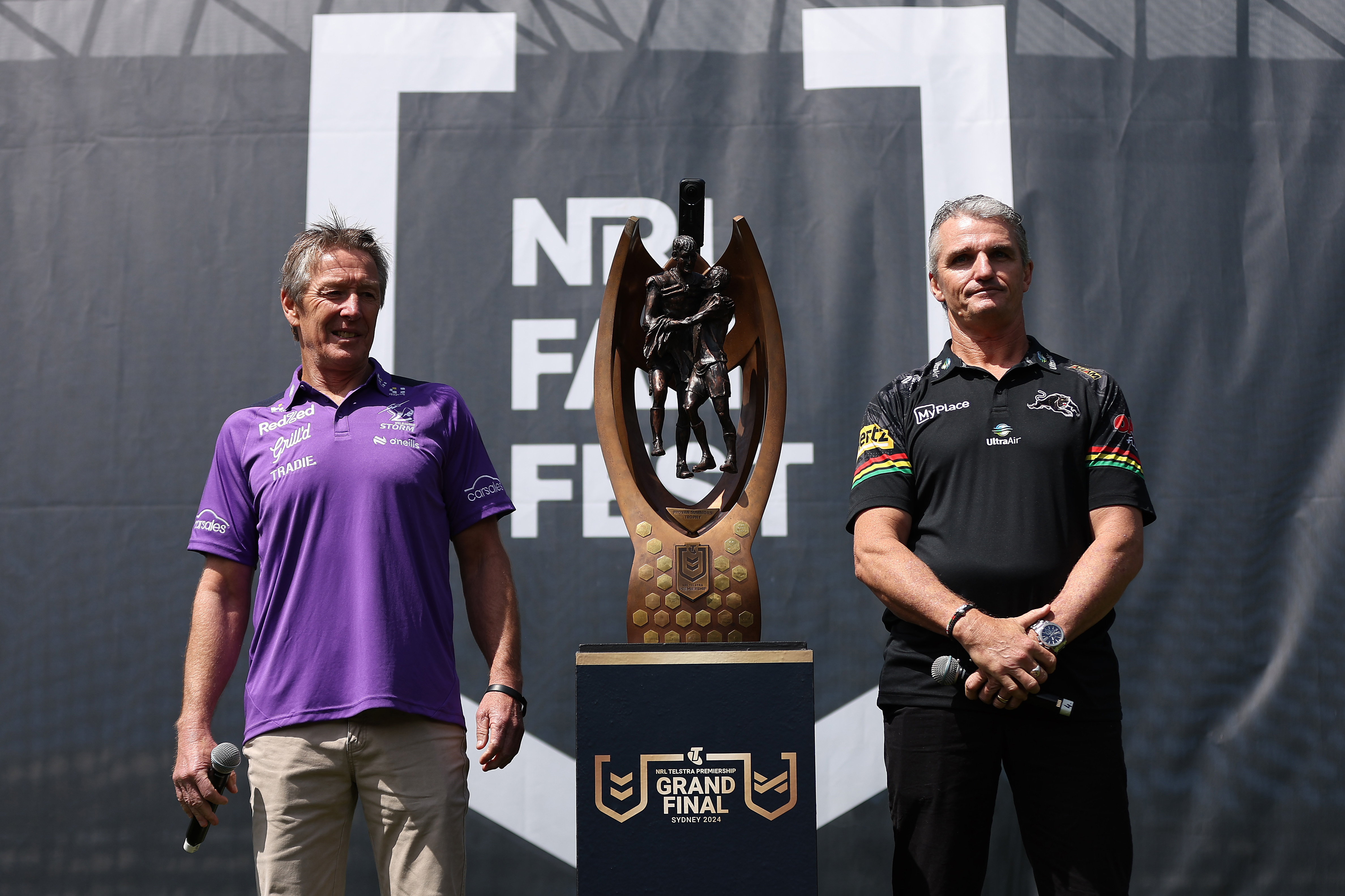 Craig Bellamy, coach of the Storm and Ivan Cleary, coach of the Panthers, pose alongside the Provan-Summons Trophy.