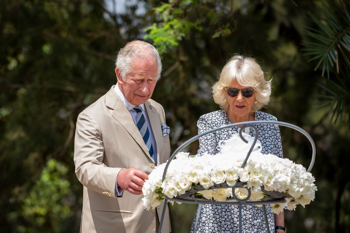 Prince Charles and Camilla, Duchess of Cornwall, observe a wreath next to the mass graves at the Kigali Genocide Memorial in the capital Kigali, Rwanda Wednesday, June 22, 2022.
