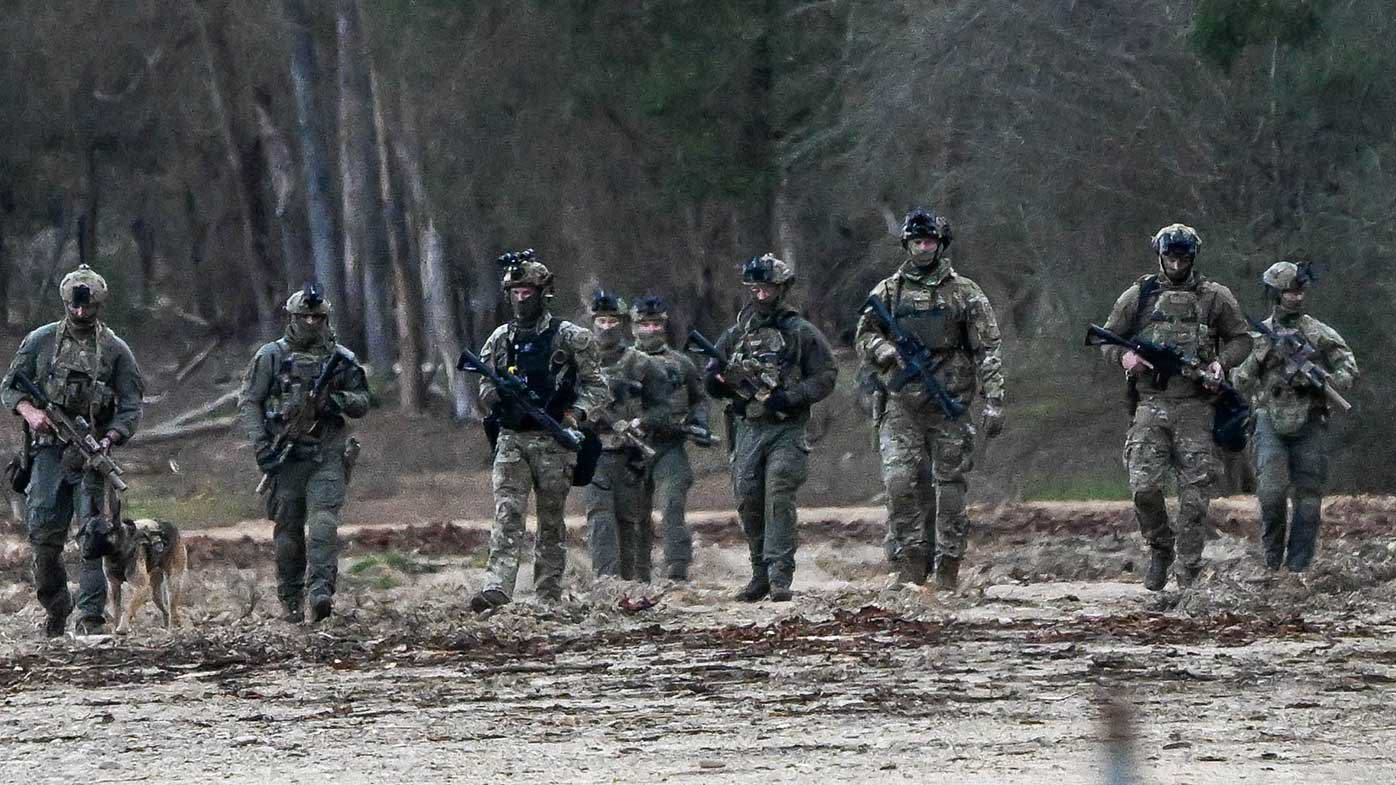 Police search a plantation at Porepunkah.
