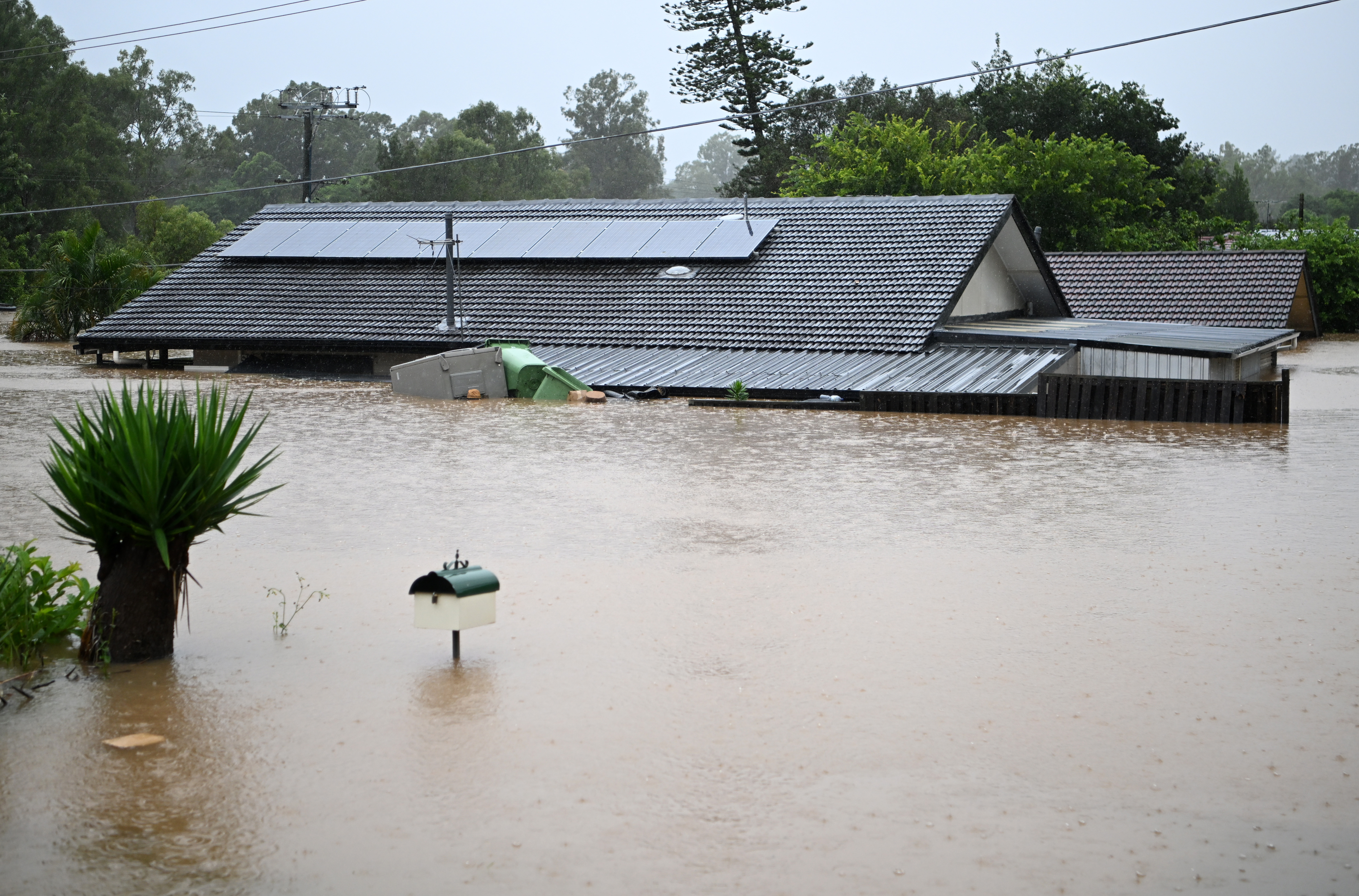 Homes were inundated by flood water yesterday in Goodna, west of Brisbane.