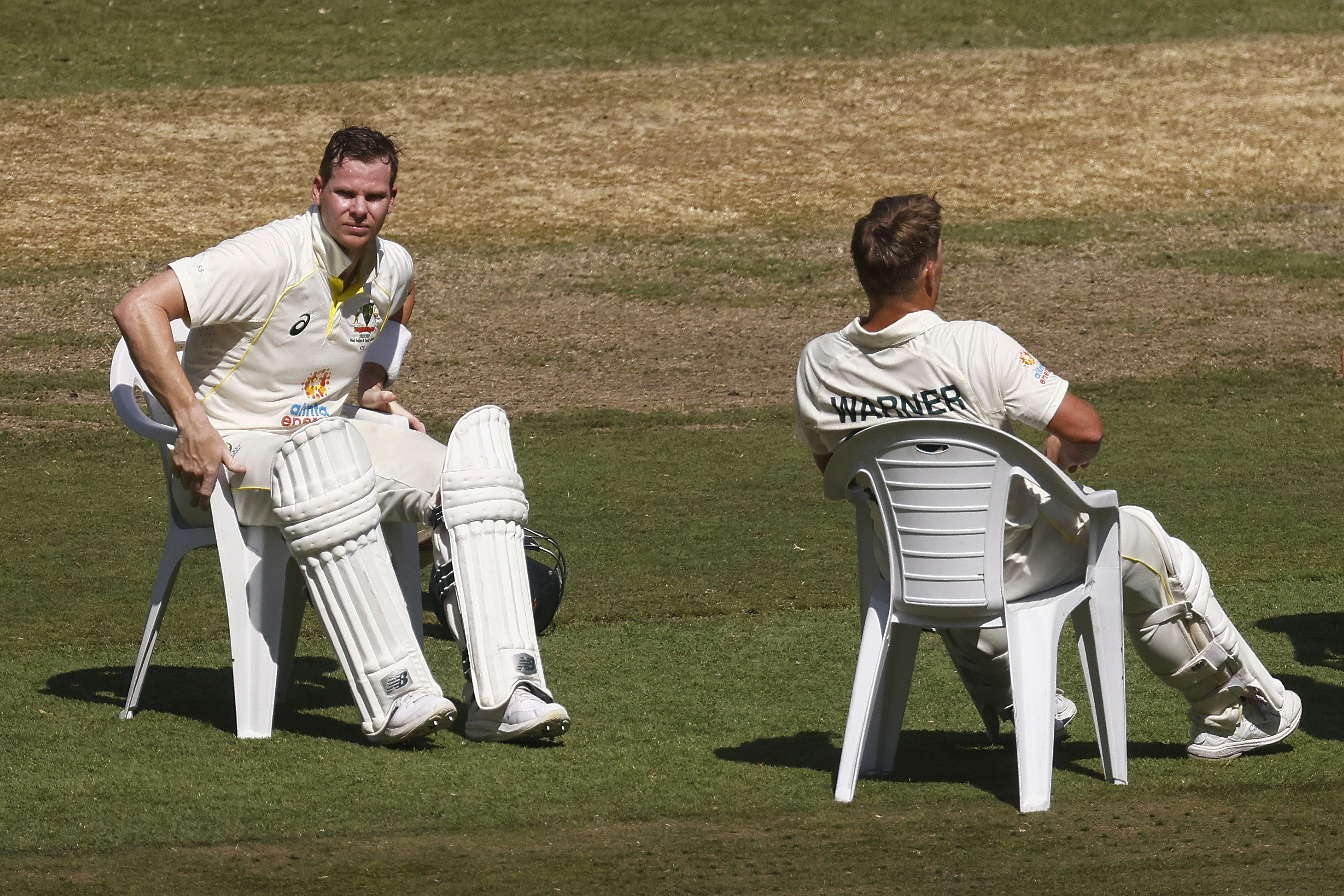 MELBOURNE, AUSTRALIA - DECEMBER 27: Steve Smith of Australia (L) and David Warner of Australia take a seat on the afternoon drinks break during day two of the Second Test match in the series between Australia and South Africa at Melbourne Cricket Ground on December 27, 2022 in Melbourne, Australia. (Photo by Daniel Pockett - CA/Cricket Australia via Getty Images)