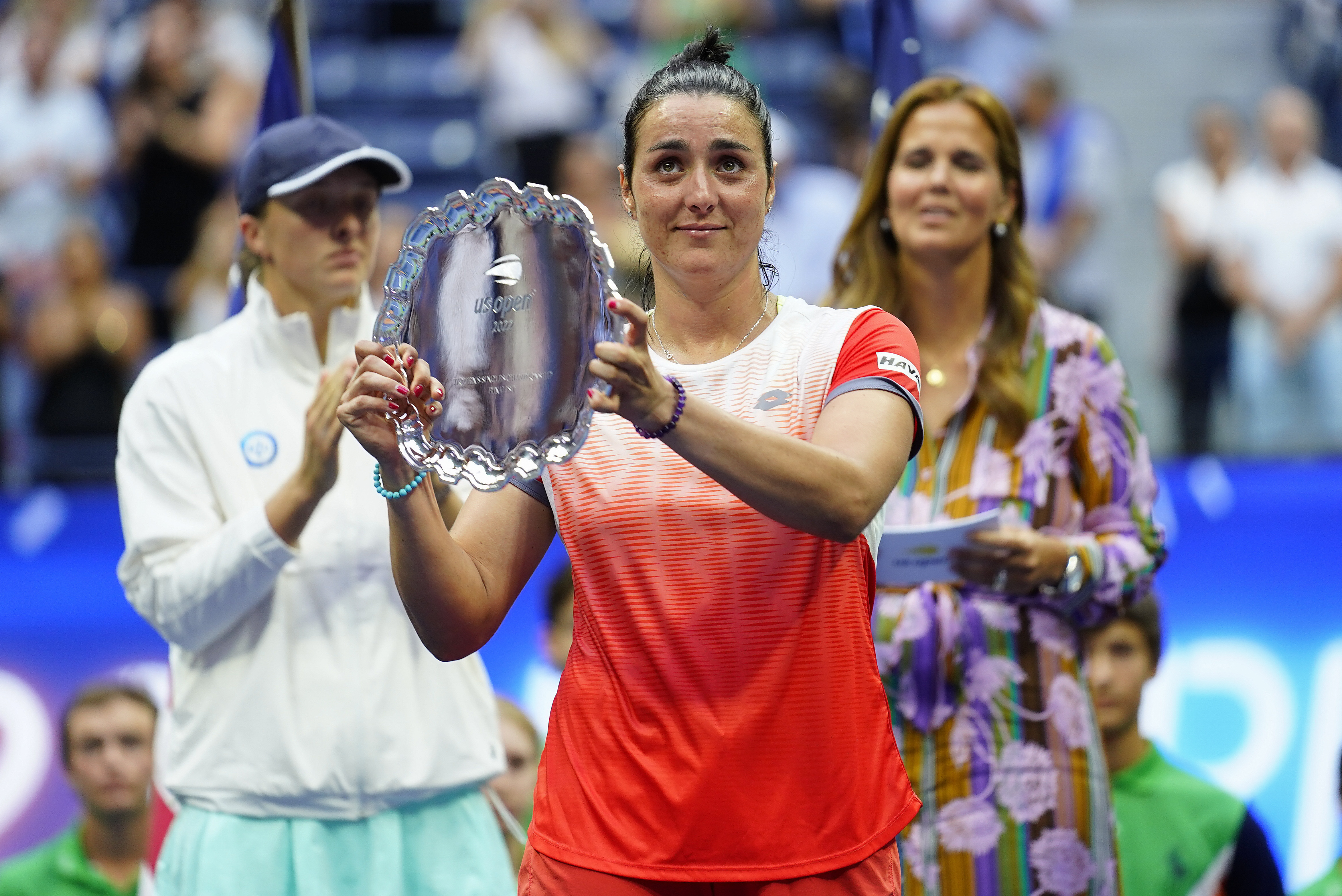 Ons Jabeur, of Tunisia, holds up the runner up trophy after losing to Iga Swiatek, of Poland, during the women's singles final of the U.S. Open tennis championships, Saturday, Sept. 10, 2022, in New York. (AP Photo/Matt Rourke)