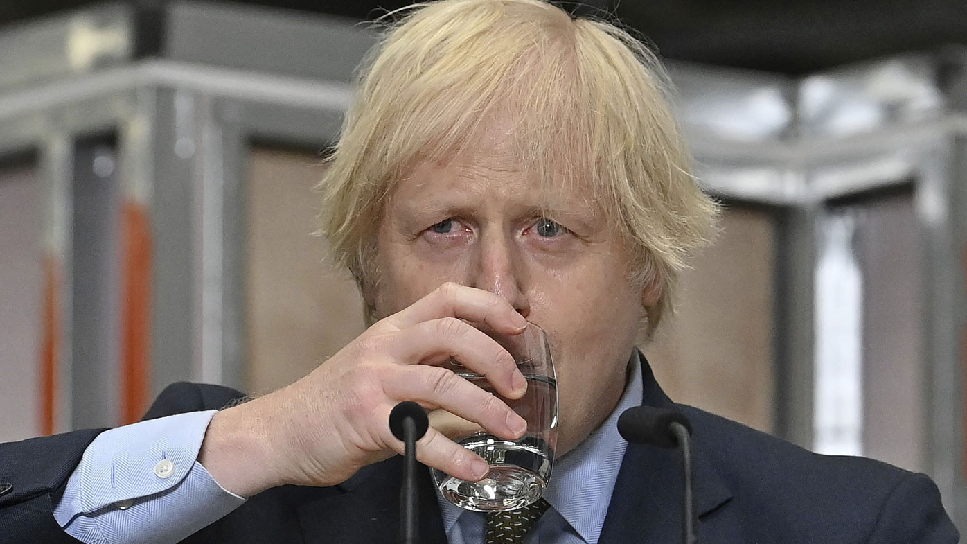 Britain's Prime Minister Boris Johnson sips water as he delivers a speech during a visit to Dudley College of Technology in Dudley, England, Tuesday June 30, 2020.