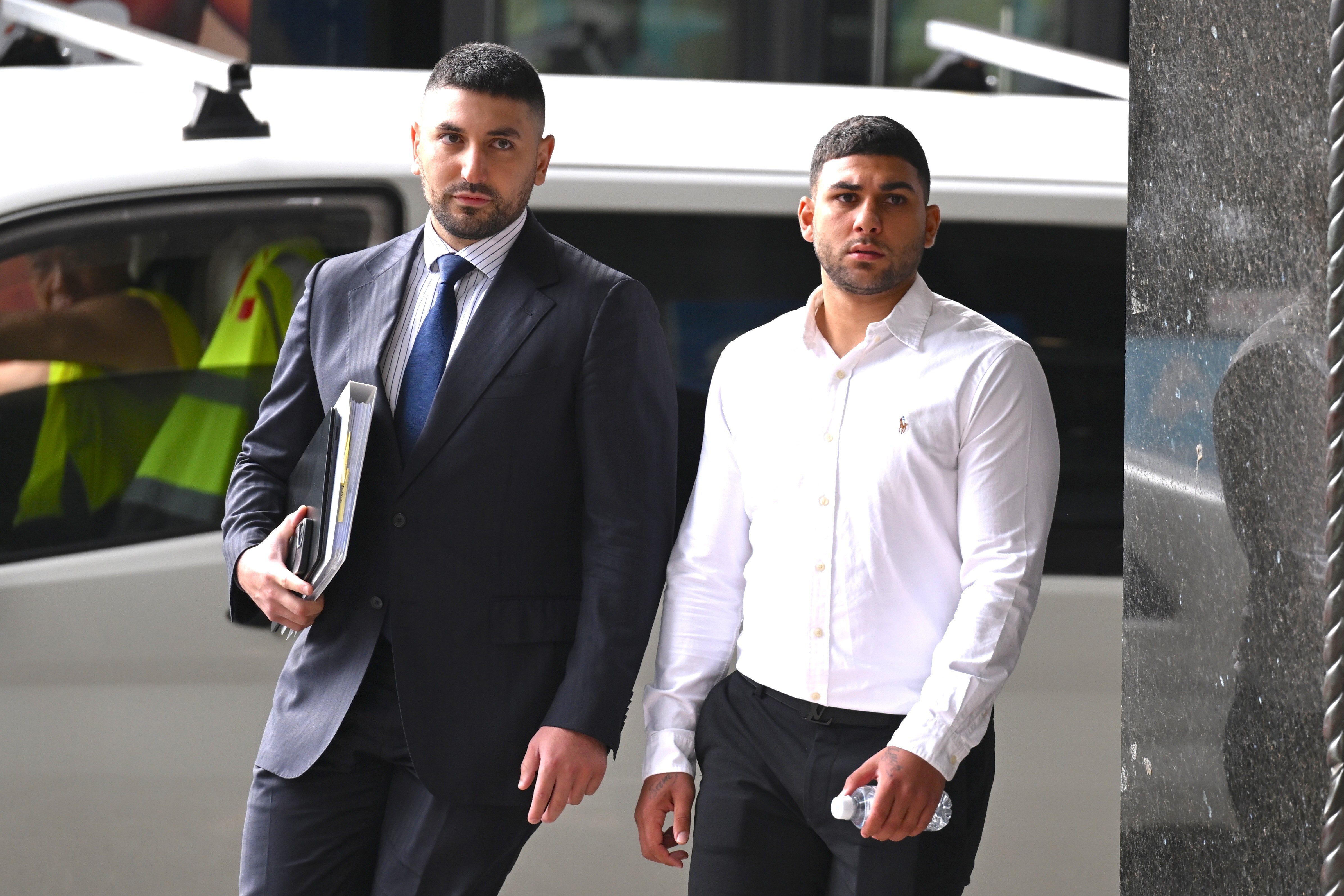 Amateur boxer Adam Abdallah (right) arrives at the Downing Centre Local Court, in Sydney, Wednesday, February 26, 2025. (AAP Image/Dean Lewins)