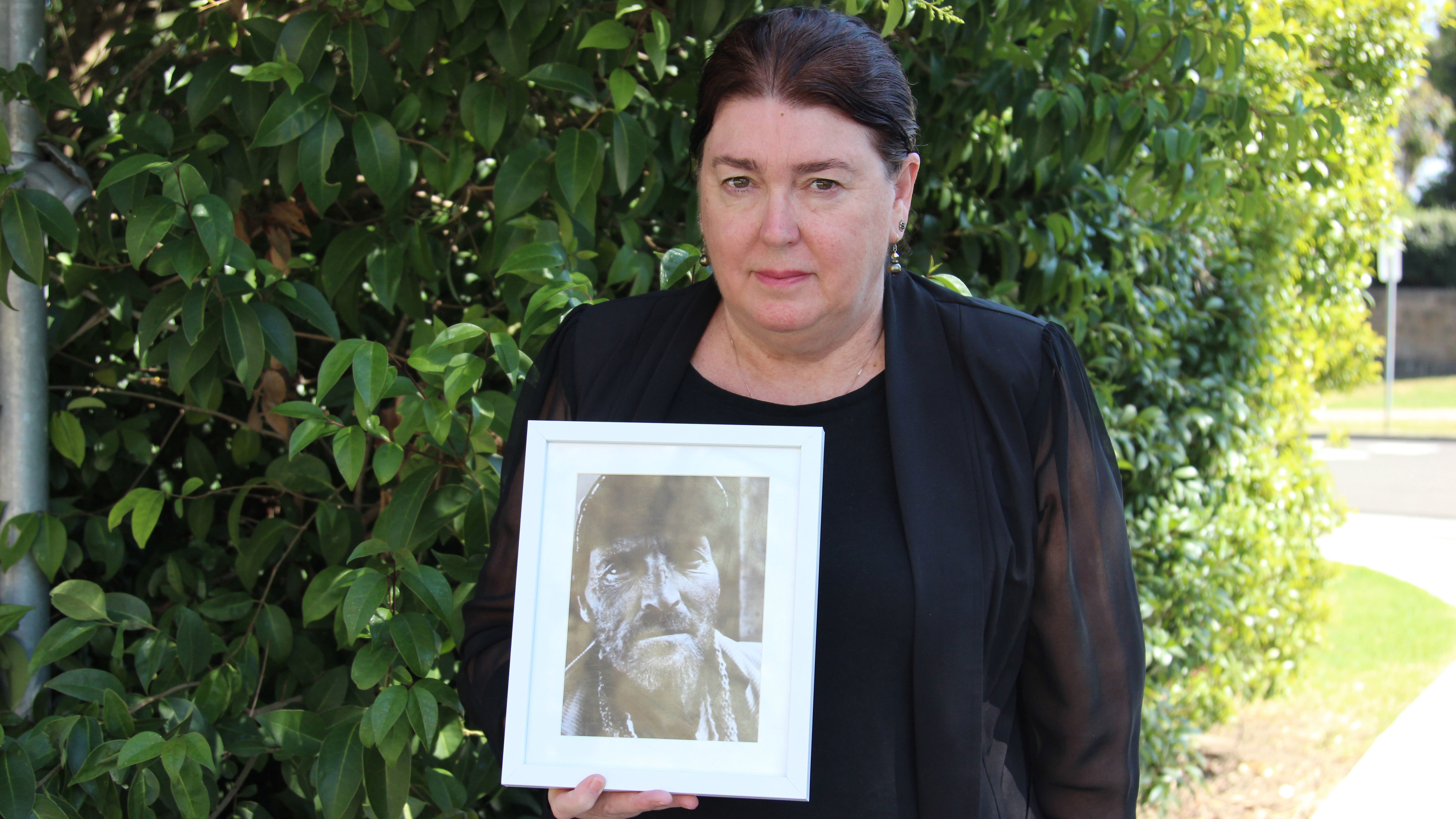 Julie Ann Stewart carries a photo of her late brother Mark Russell who was murdered almost five years ago. 