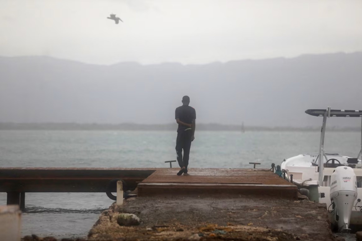 A person looks out at the sea as Hurricane Melissa approaches in Port Royal, Jamaica, October 27.