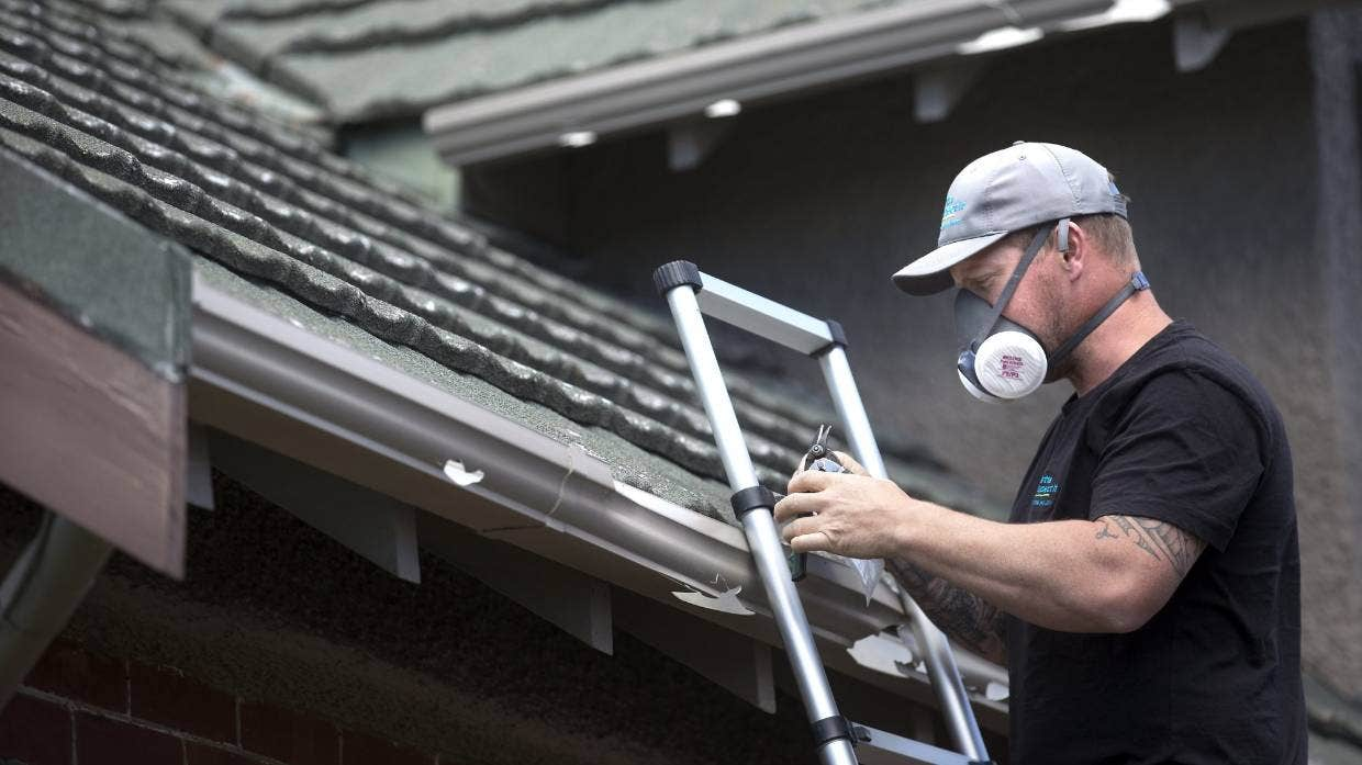 Betta Inspect It building inspector Craig O'Keefe checks hail-damaged roofs in Christchurch for asbestos