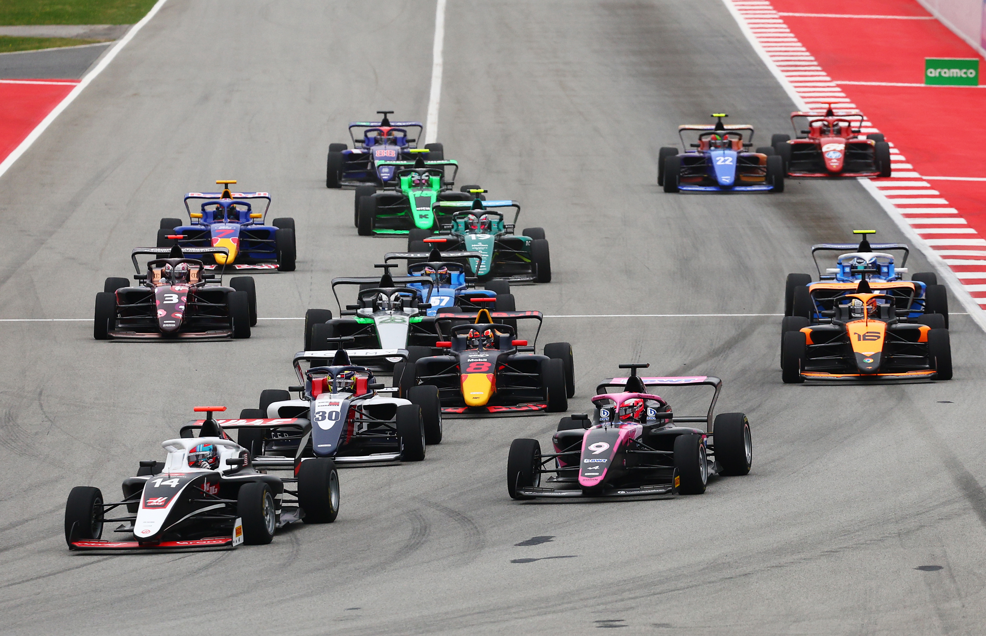 Chloe Chambers of United States and Campos Racing leads Abbi Pulling of Great Britain and Rodin Motorsport and the rest of the field into turn one at the start during the F1 Academy race at the Spanish Grand Prix.