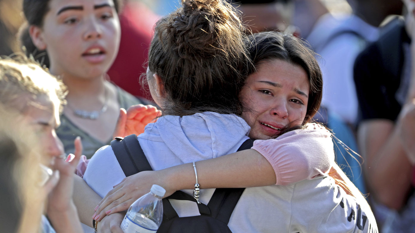 Students embrace at Marjory Stoneman Douglas High School in Parkland, Florida, after the mass shooting.