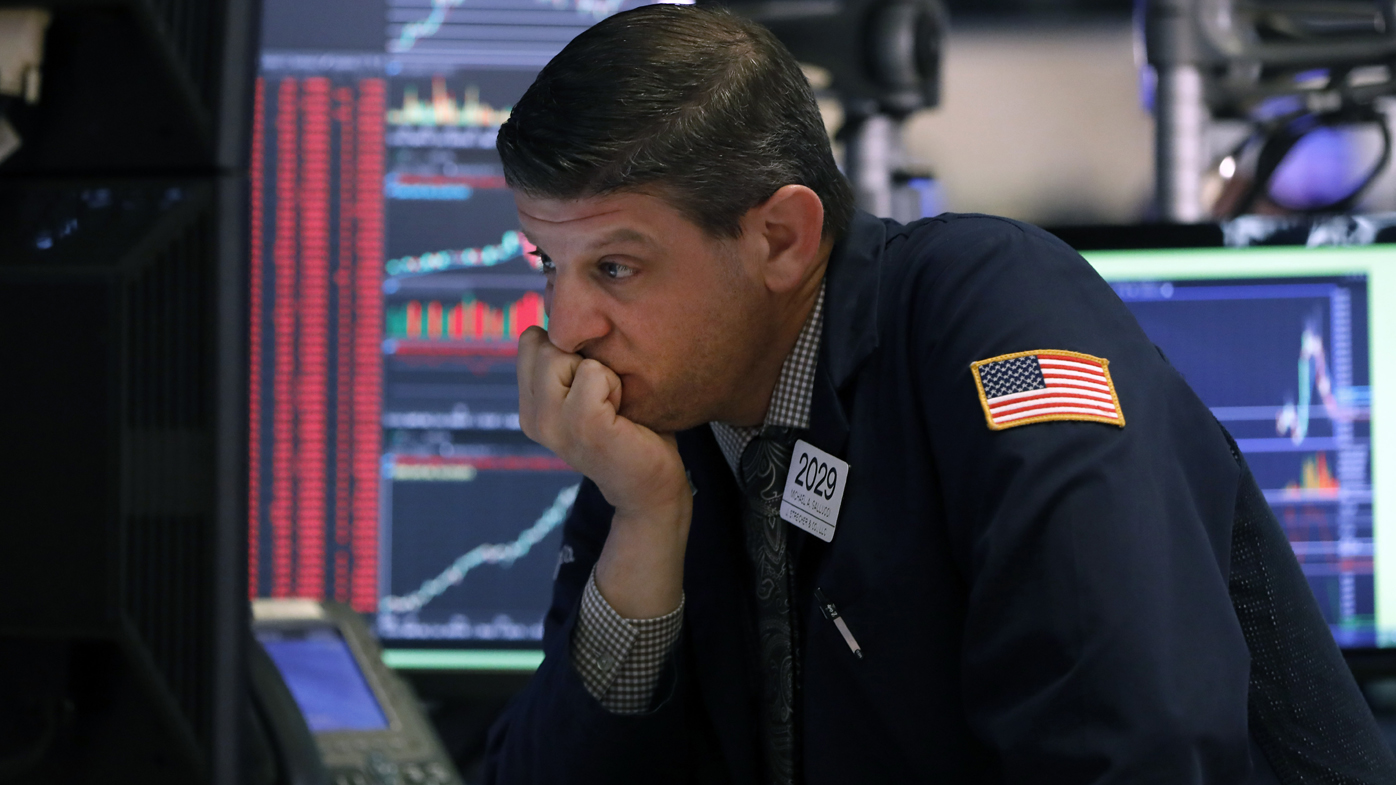 Trader Michael Gallucci works at his post on the floor of the New York Stock Exchange today. Trading was halted as stocks plummeted on the back of coronavirus concerns.