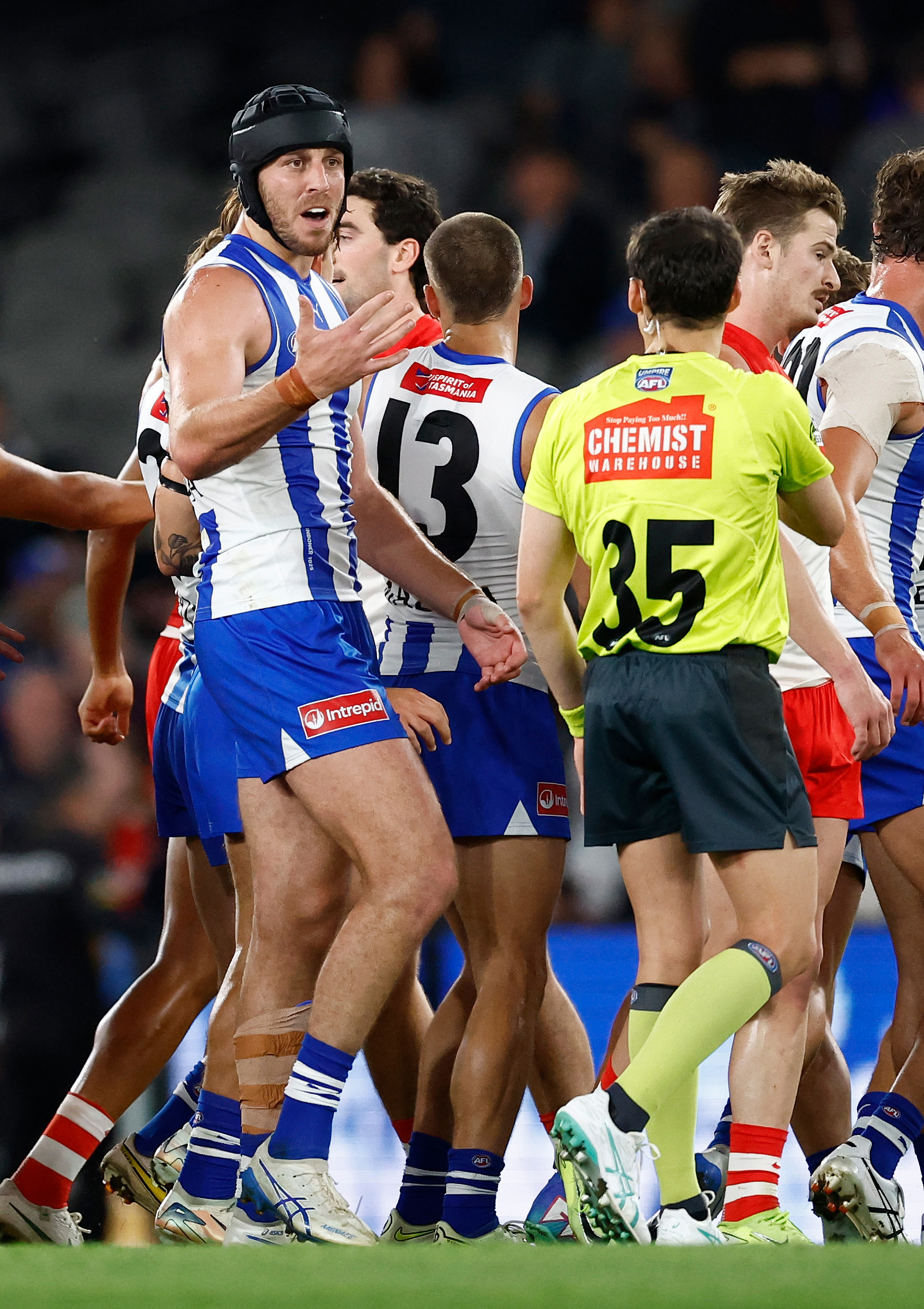 Tristan Xerri of the Kangaroos speaks with the umpire during the 2025 AFL Round 04 match between the North Melbourne Kangaroos and the Sydney Swans at Marvel Stadium on April 5, 2025 in Melbourne, Australia. (Photo by Michael Willson/AFL Photos via Getty Images)