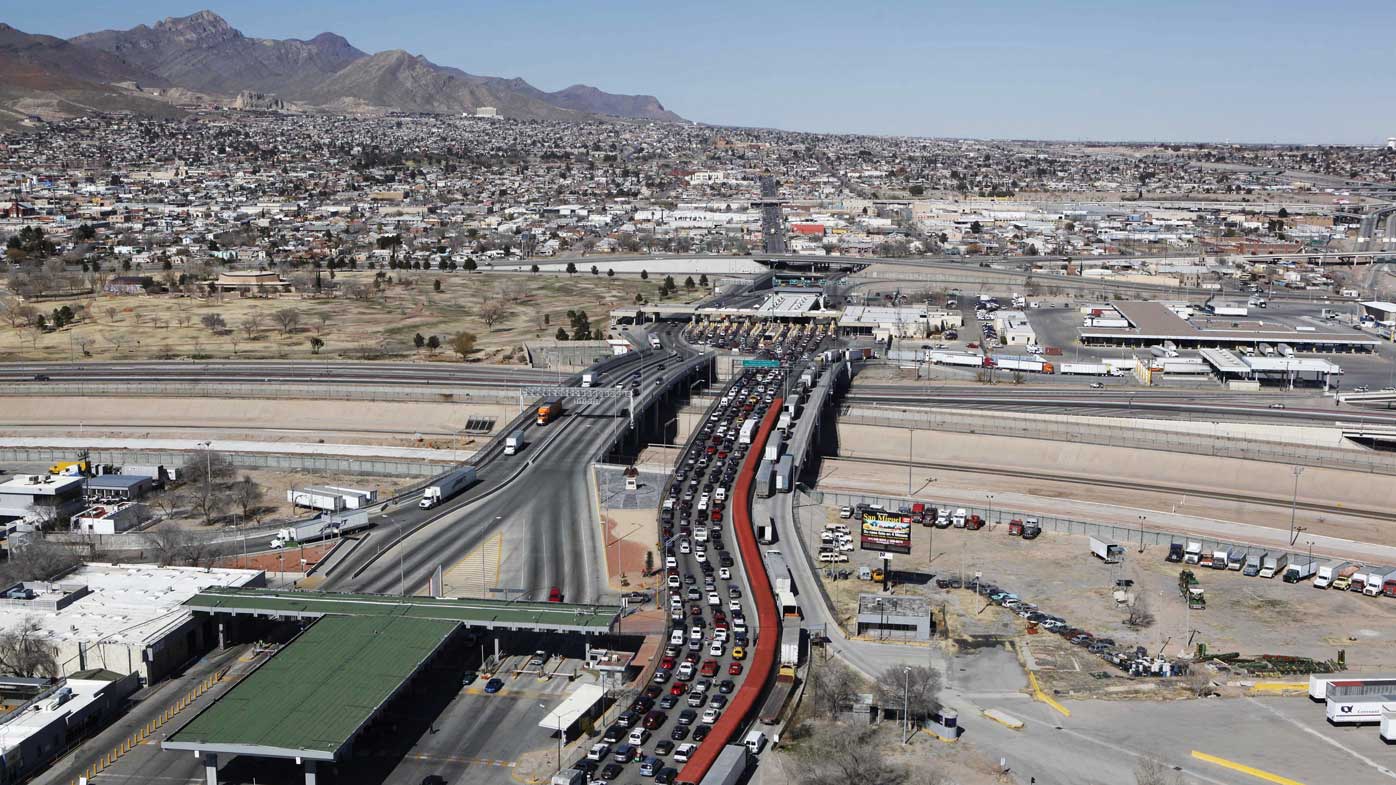 The border between Mexico and the United States. Trucks stream from El Paso in the US (left) as traffic is clogged from Ciudad Juarez, Mexico, on the right. (AAP)
