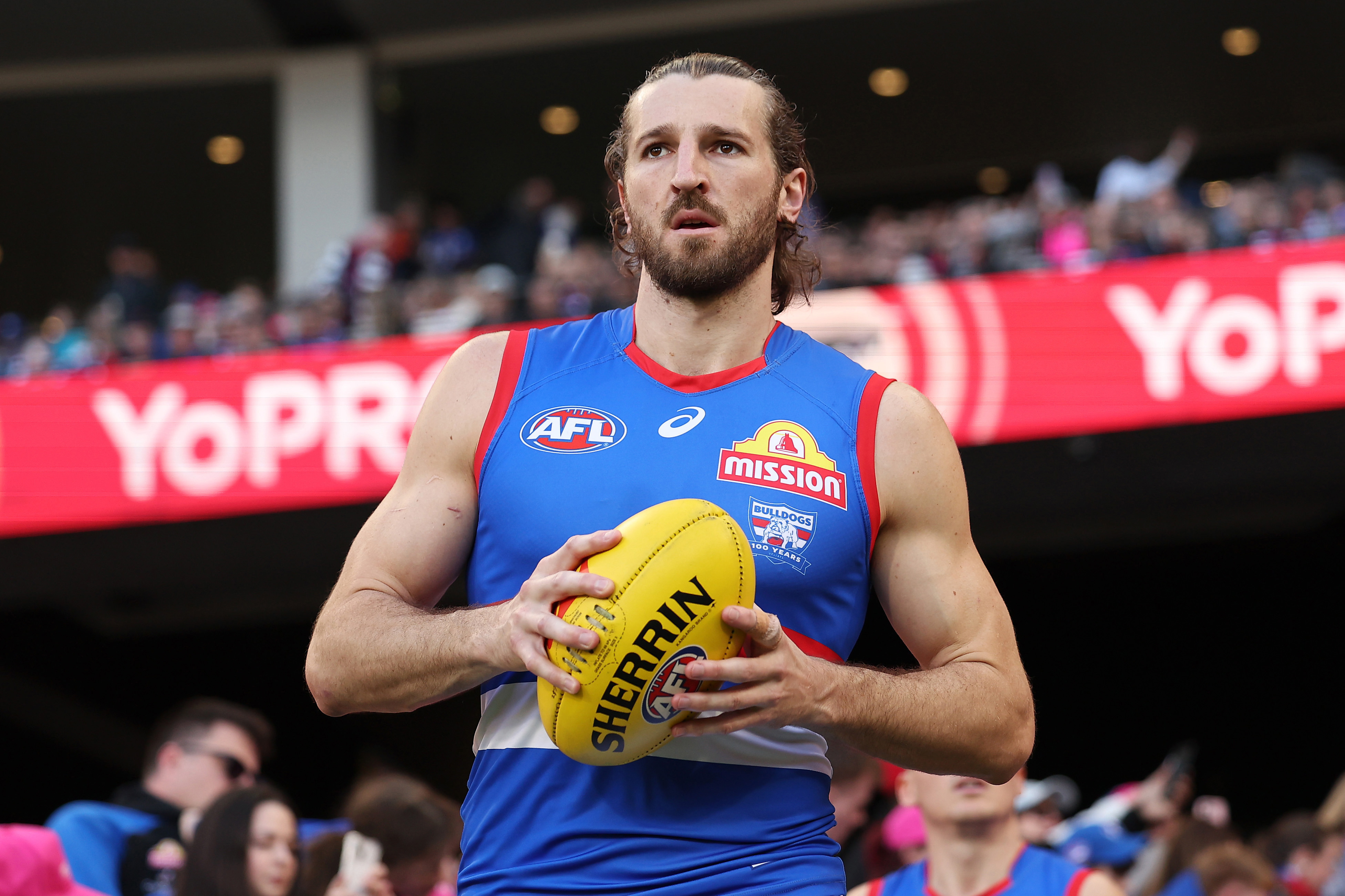 Marcus Bontempelli of the Bulldogs leads the team out.