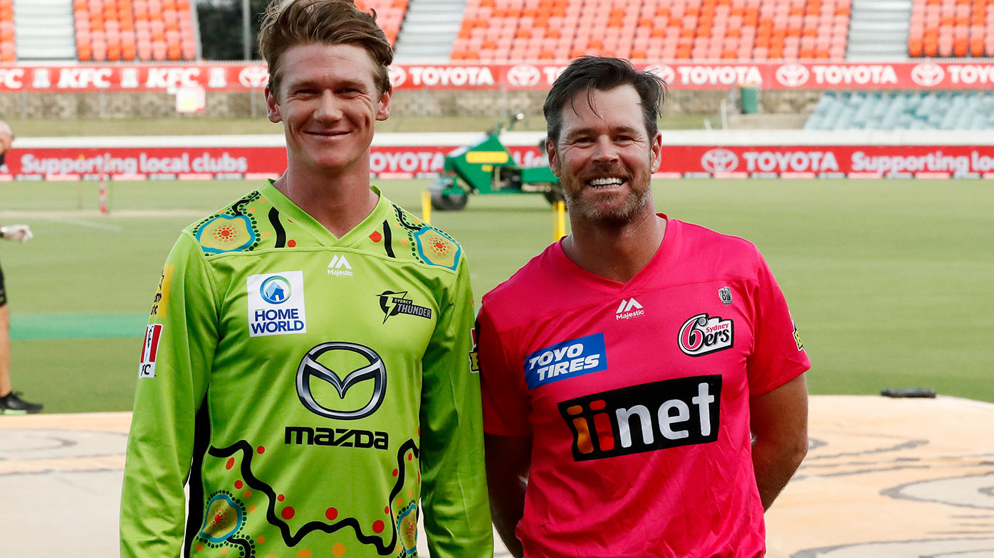 Members of the Indigenous Mens Cricket team Brendan Doggett of the Thunder and Dan Christian of the Sixers take part in a bare foot ceremony around the the 'Walkabout Wickets' art work by proud Kirrae Whurrong woman Aunty Fiona Clarke before the Big Bash League match between the Sydney Thunder and the Sydney Sixers at Manuka Oval, on January 13, 2021