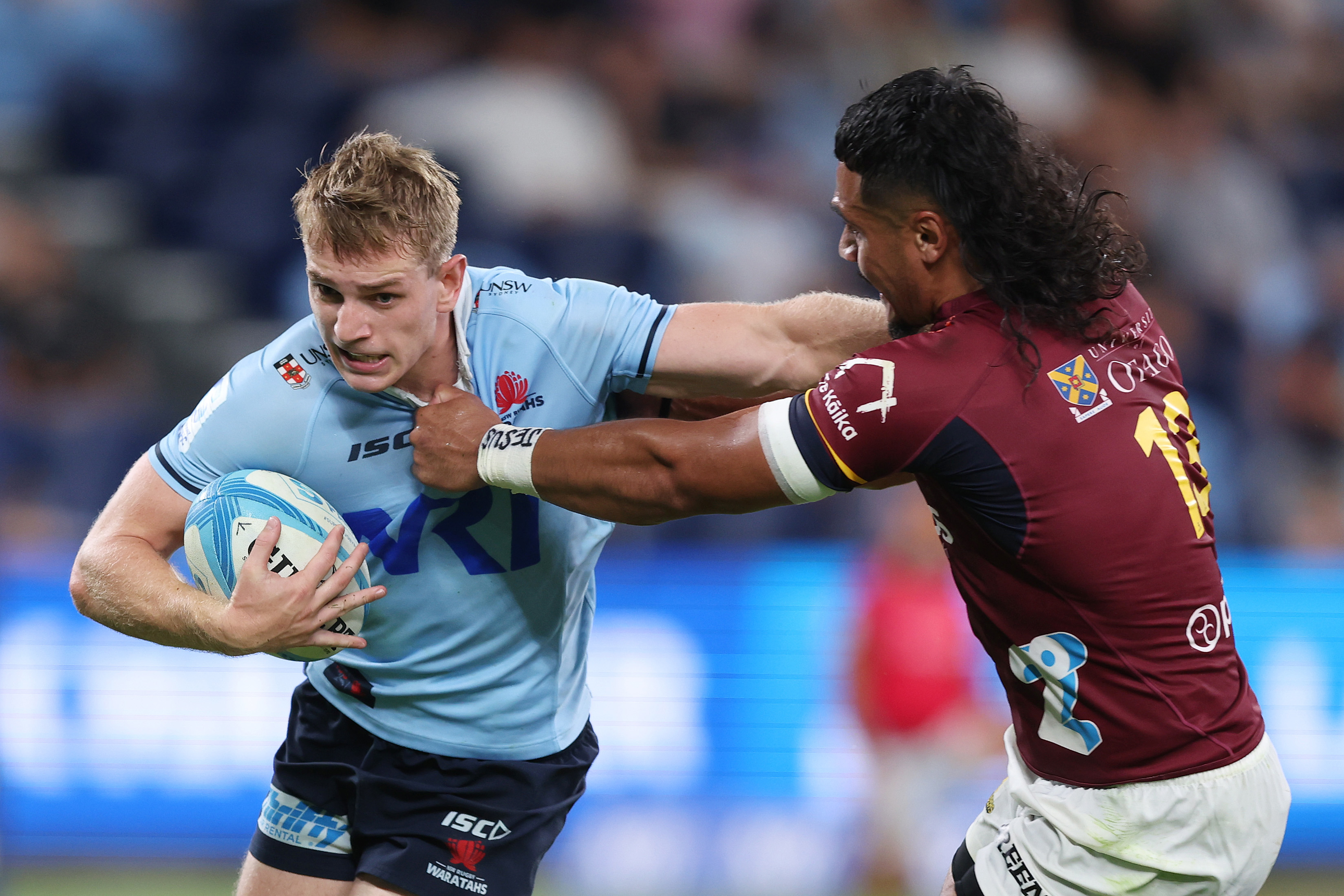 Max Jorgensen of the Waratahs is tackled by Tanielu Telea of the Highlanders during the round three Super Rugby Pacific match.