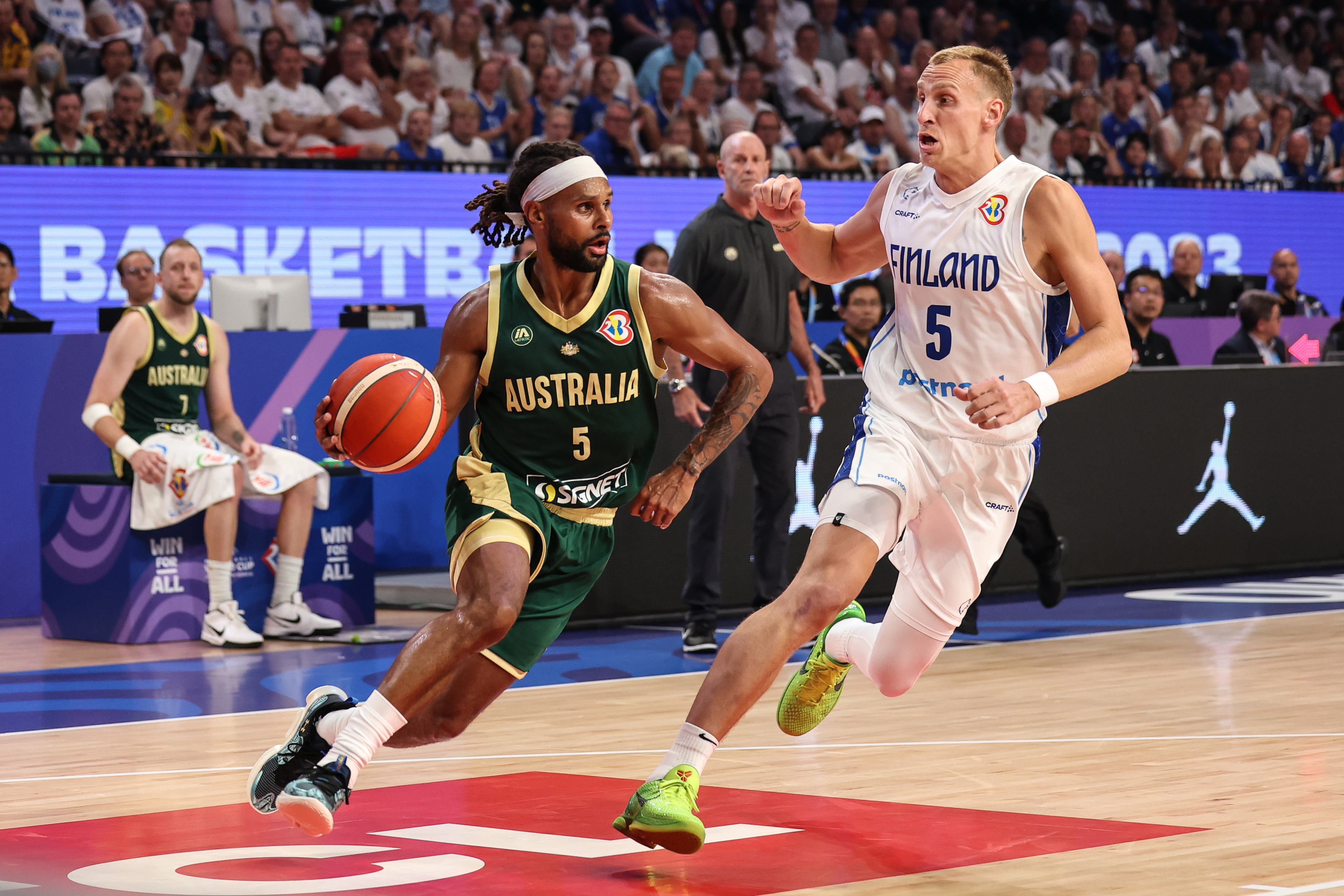 Patty Mills drives to the basket against Alex Murphy of Finland.