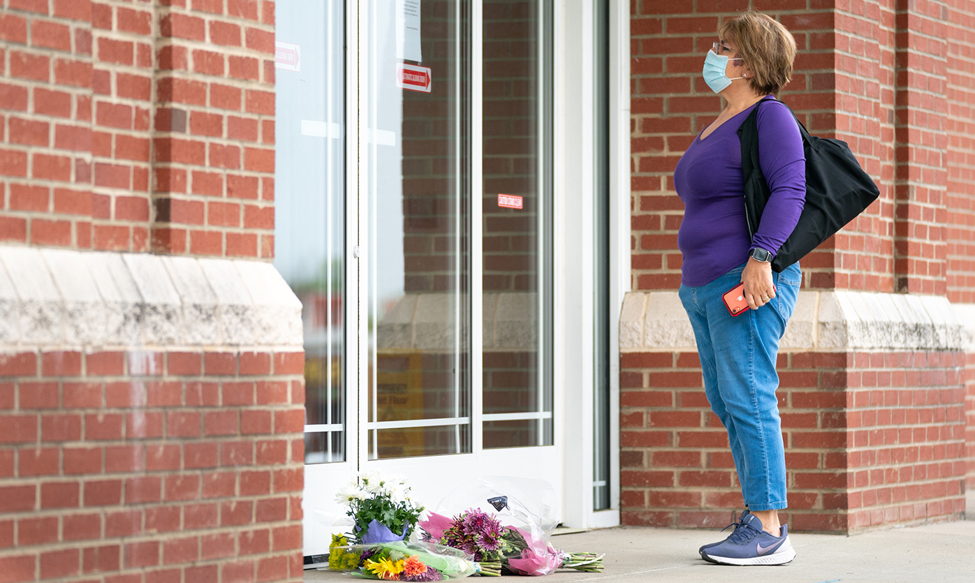 A woman reads a note explaining the temporary closure of Riverview Family Medicine and Urgent Care after the fatal shooting of Dr Robert Lesslie and four others on April 8.
