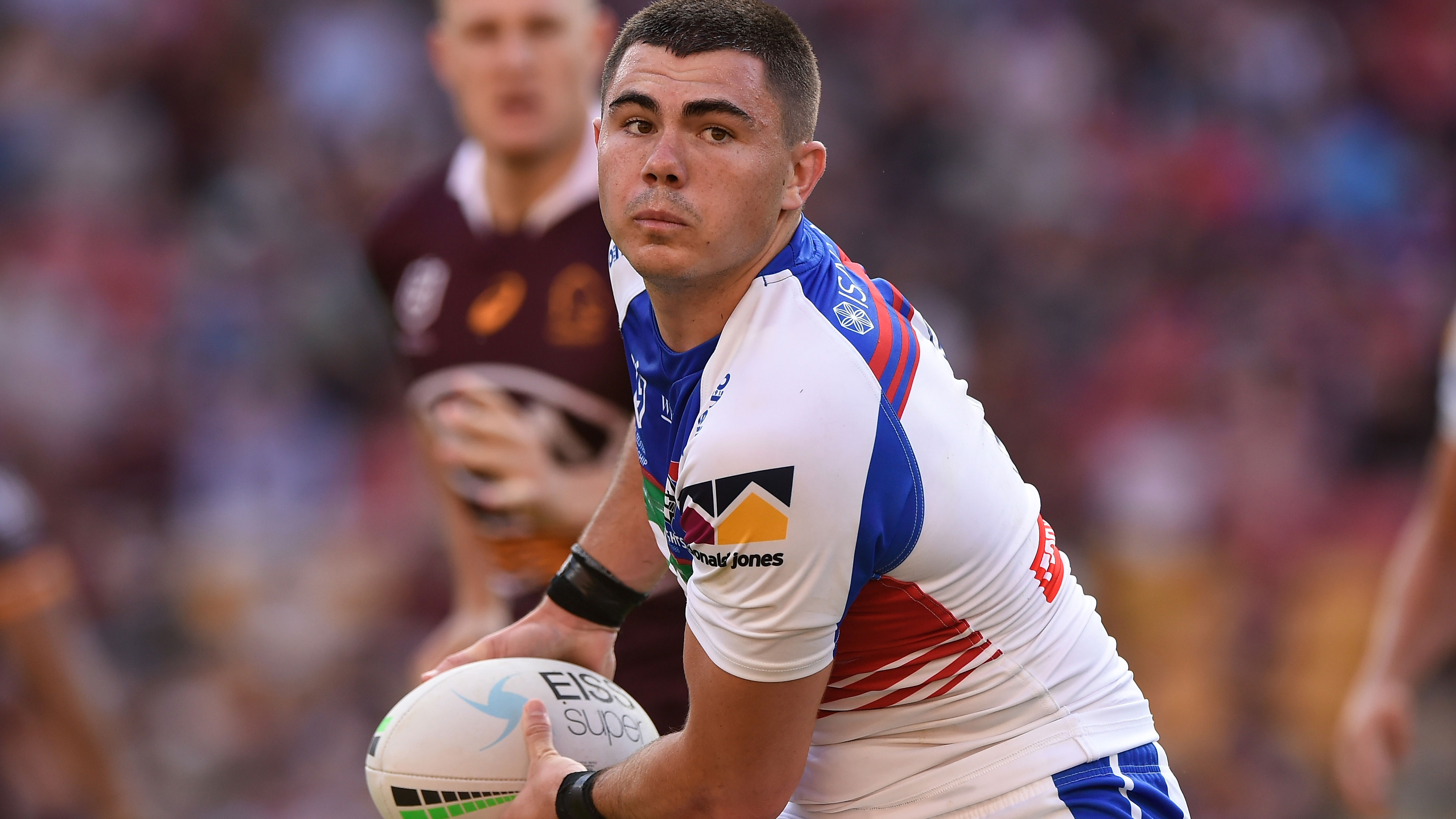 Jake Clifford of the Knights passes the ball during their Round 25 match against the Brisbane Broncos.