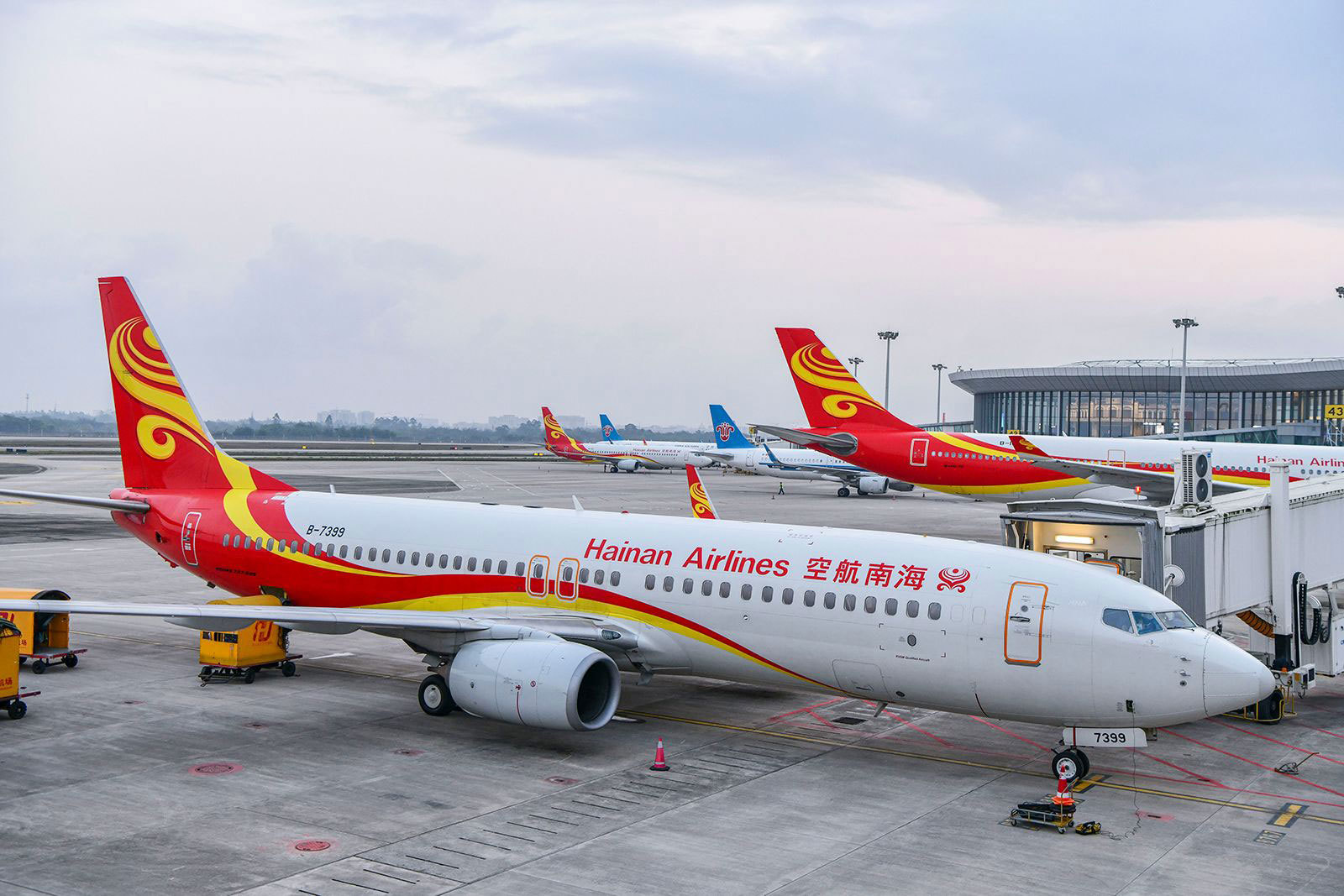 Hainan Airlines planes sit on the tarmac.