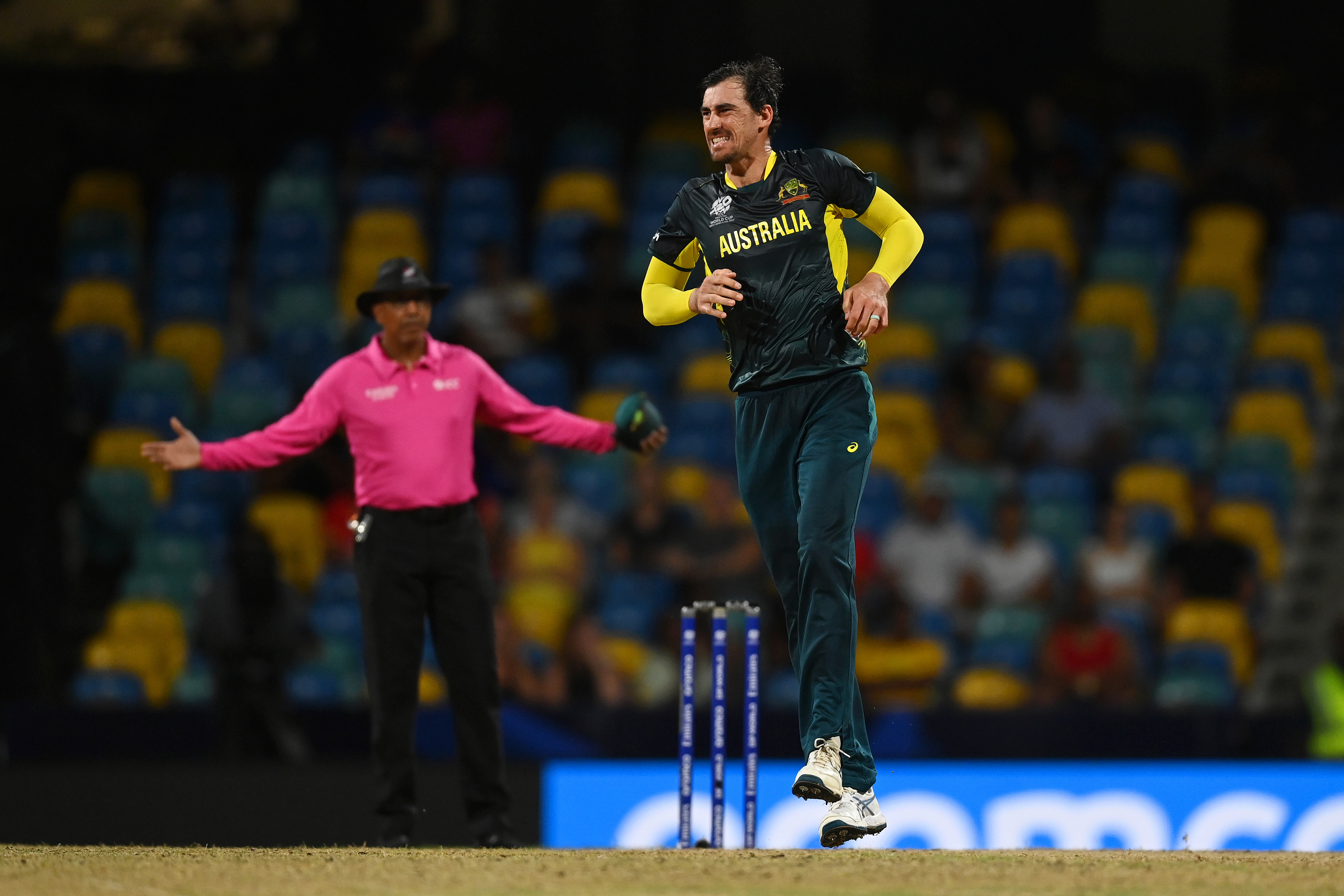 Mitchell Starc of Australia reacts after a suffering an apparent calf injury in a delivery during the ICC Men's T20 Cricket World Cup West Indies & USA 2024 match between Australia  and Oman at  Kensington Oval on June 05, 2024 in Bridgetown, Barbados. (Photo by Gareth Copley/Getty Images)