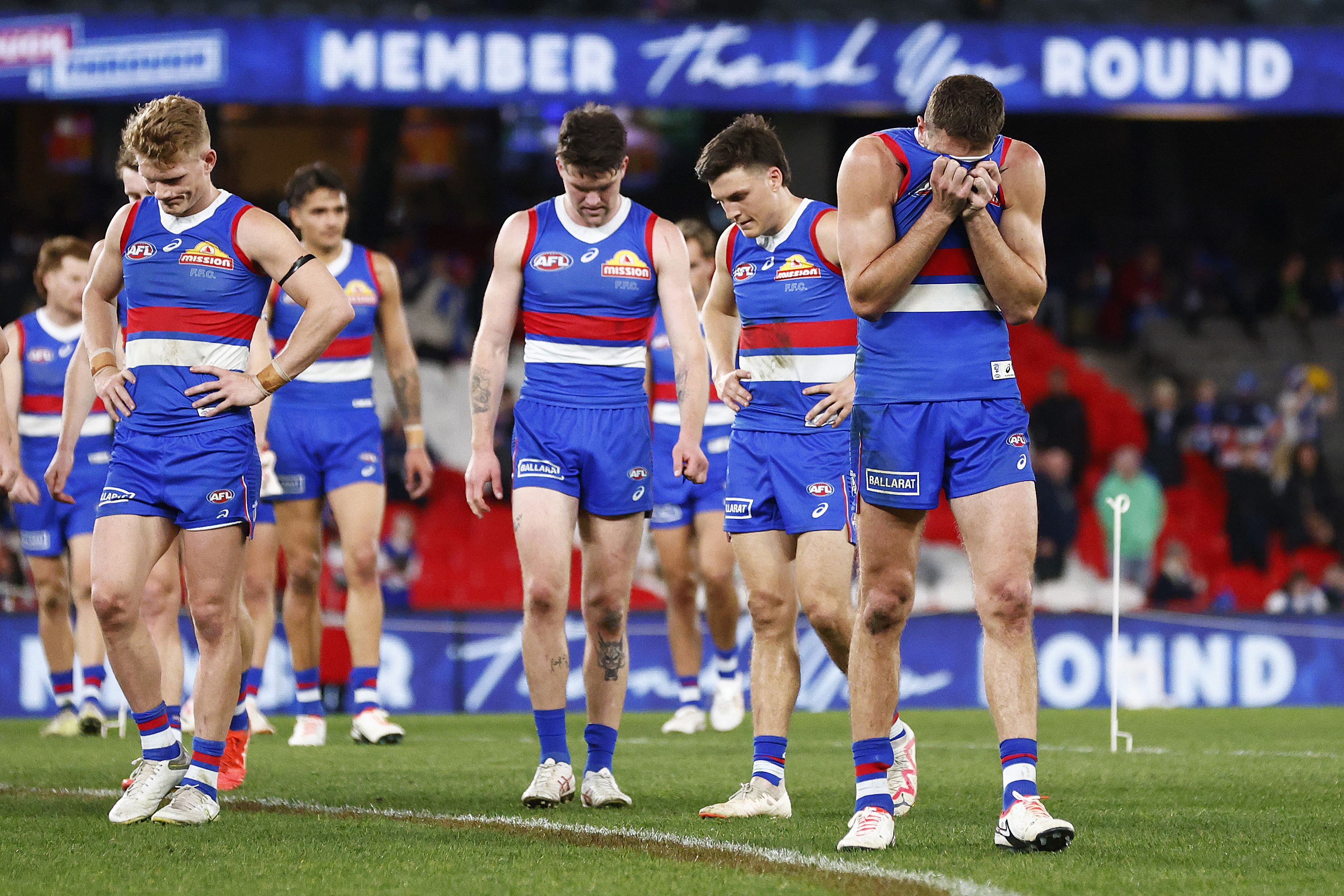 MELBOURNE, AUSTRALIA - AUGUST 20: Marcus Bontempelli of the Bulldogs (R) and his players look dejected as they leave the field after the round 23 AFL match between Western Bulldogs and West Coast Eagles at Marvel Stadium, on August 20, 2023, in Melbourne, Australia. (Photo by Daniel Pockett/Getty Images)