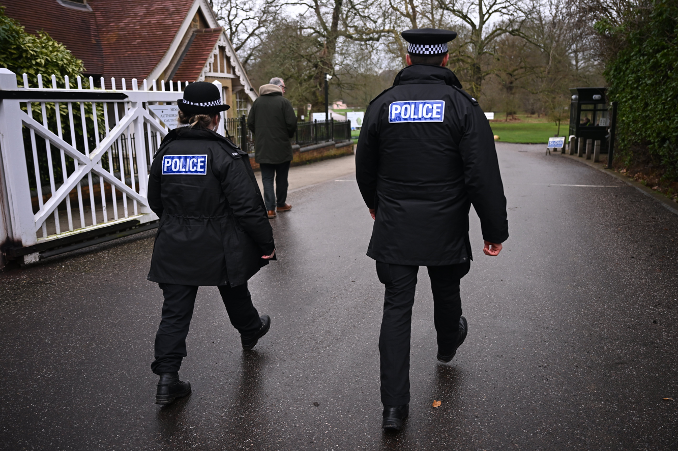 Police officers patrol near the Royal Lodge, Andrew Mountbatten-Windsor's former residence in Windsor Great Park.