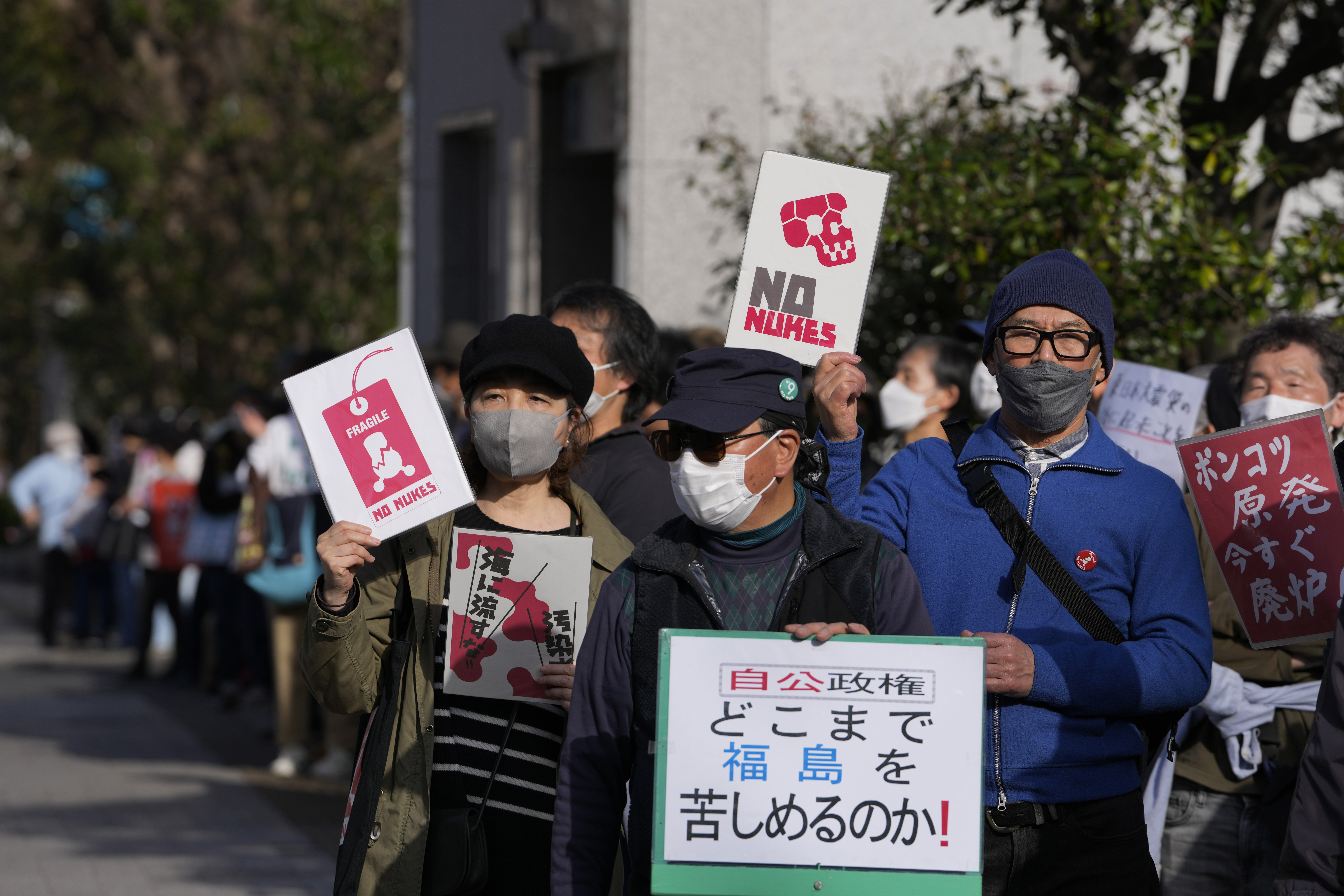 People chant slogans during a protest against the Japanese government of using the nuclear power, gathering across from the prime minister's official residence in Tokyo, Saturday, March 11, 2023, on the 12th anniversary of a disaster following a devastating earthquake and tsunami in Japan's Tohoku region. 