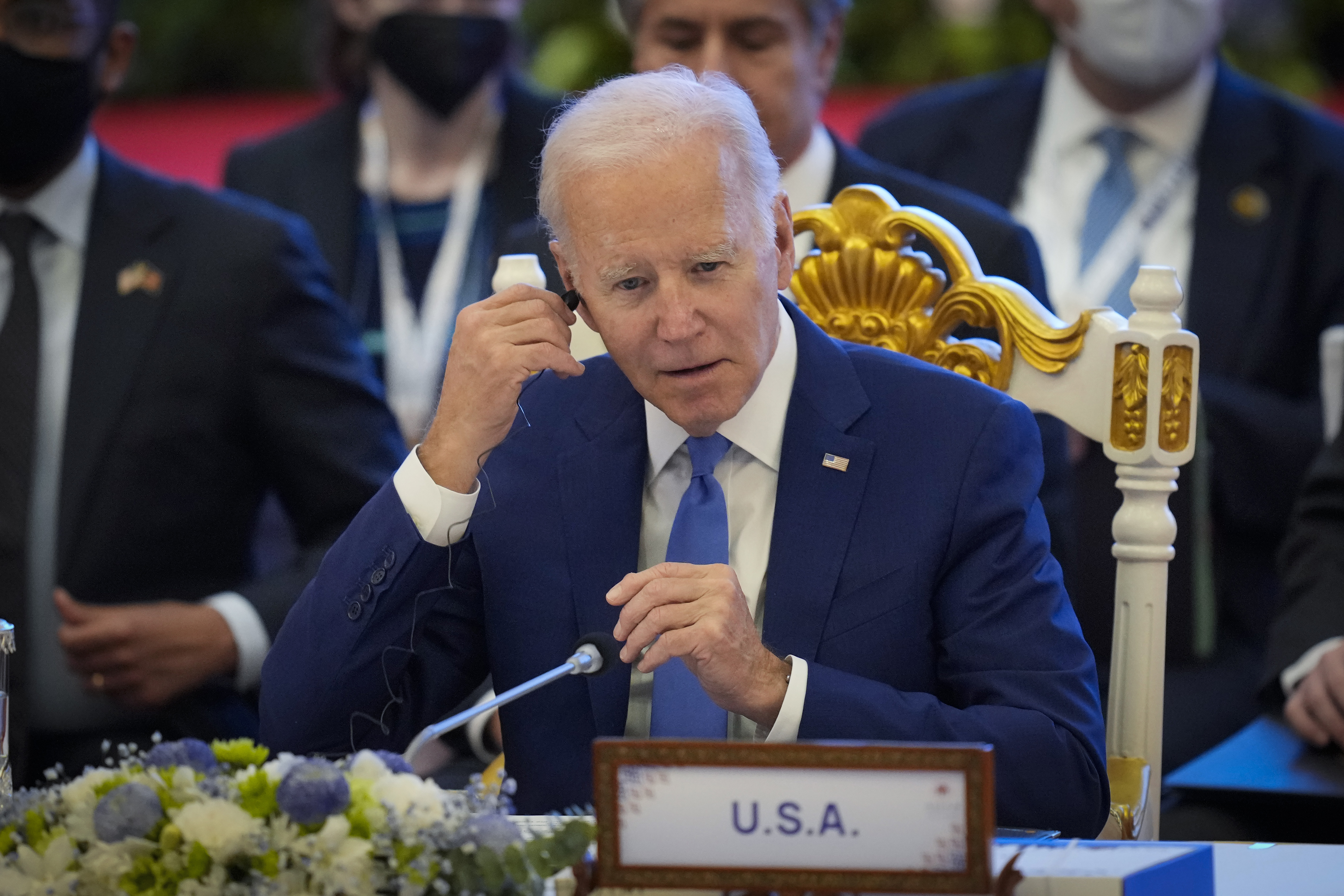 U.S. President Joe Biden adjust his earphone during the ASEAN - US (Association of Southeast Asian Nations) in Phnom Penh, Cambodia, Saturday, Nov. 12, 2022. (AP Photo/Vincent Thian)