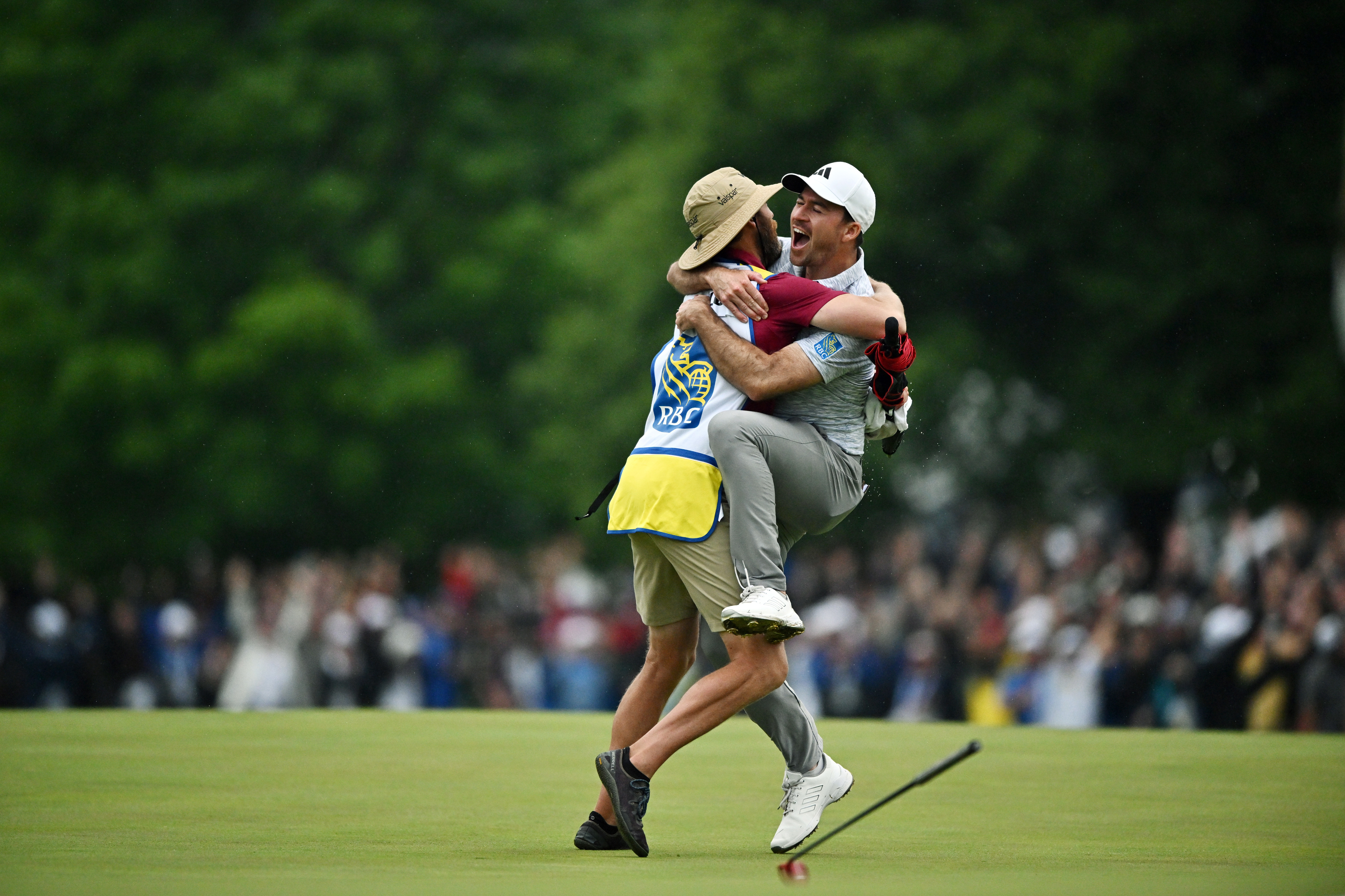 Nick Taylor of Canada celebrates with his caddie after making an eagle putt on the 4th playoff hole to win the RBC Canadian Open at Oakdale Golf & Country Club on June 11, 2023 in Toronto, Ontario. (Photo by Minas Panagiotakis/Getty Images)