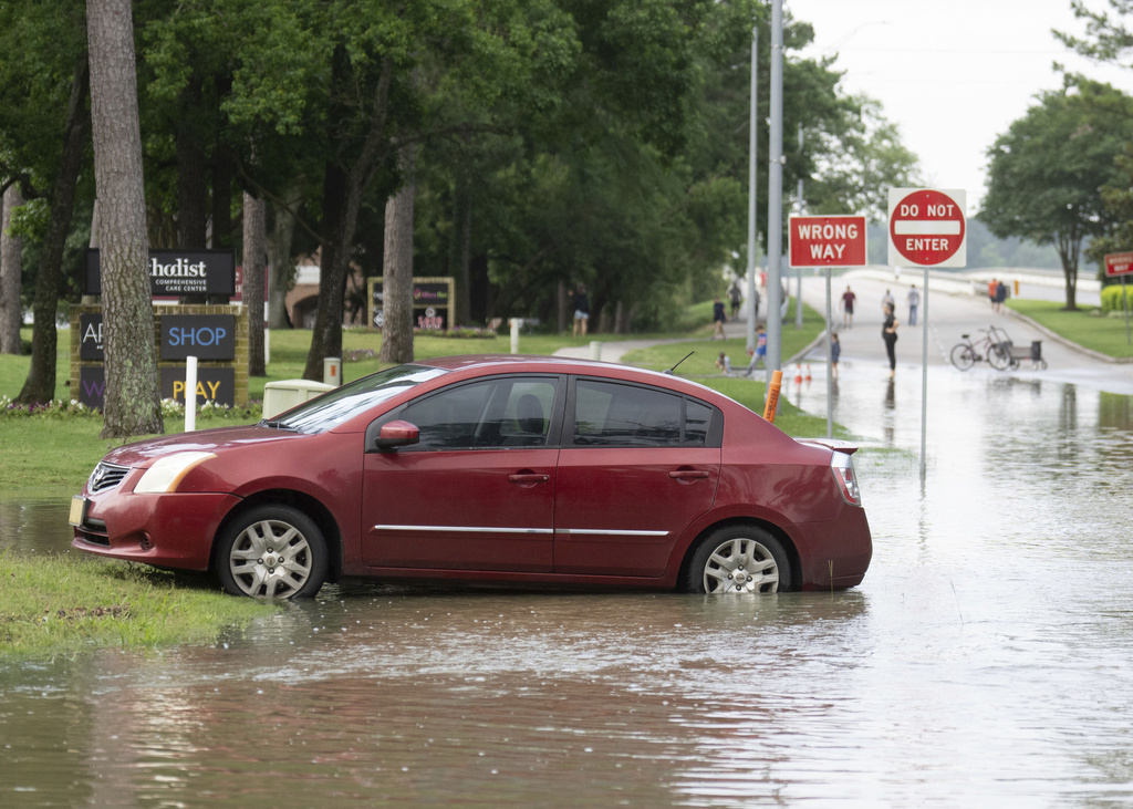 A stranded care is seen near the bridge over Lake Houston along West Lake Houston Parkway after it was closed due to high water on either side of the thoroughfare, Saturday, May 4, 2024, in Kingwood, Texas. (Jason Fochtman/Houston Chronicle via AP)