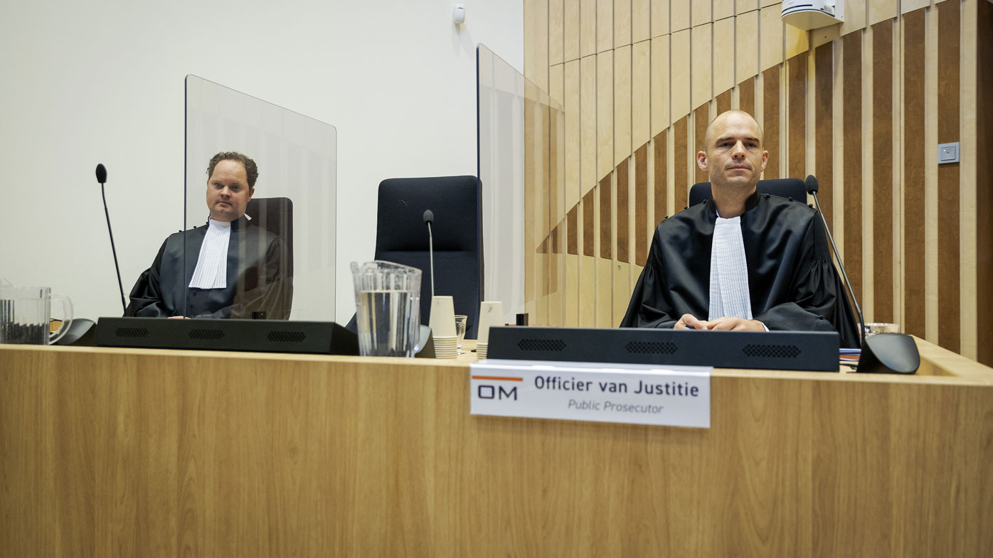 Public prosecutor Ward Ferdinandusse, right, waits for the trial to resume at the high security court building at Schiphol Airport, near Amsterdam, Monday, June 8, 2020, for three Russians and a Ukrainian charged with crimes including murder for their alleged roles in the shooting down of Malaysia Airlines Flight MH17 over eastern Ukraine nearly six years ago