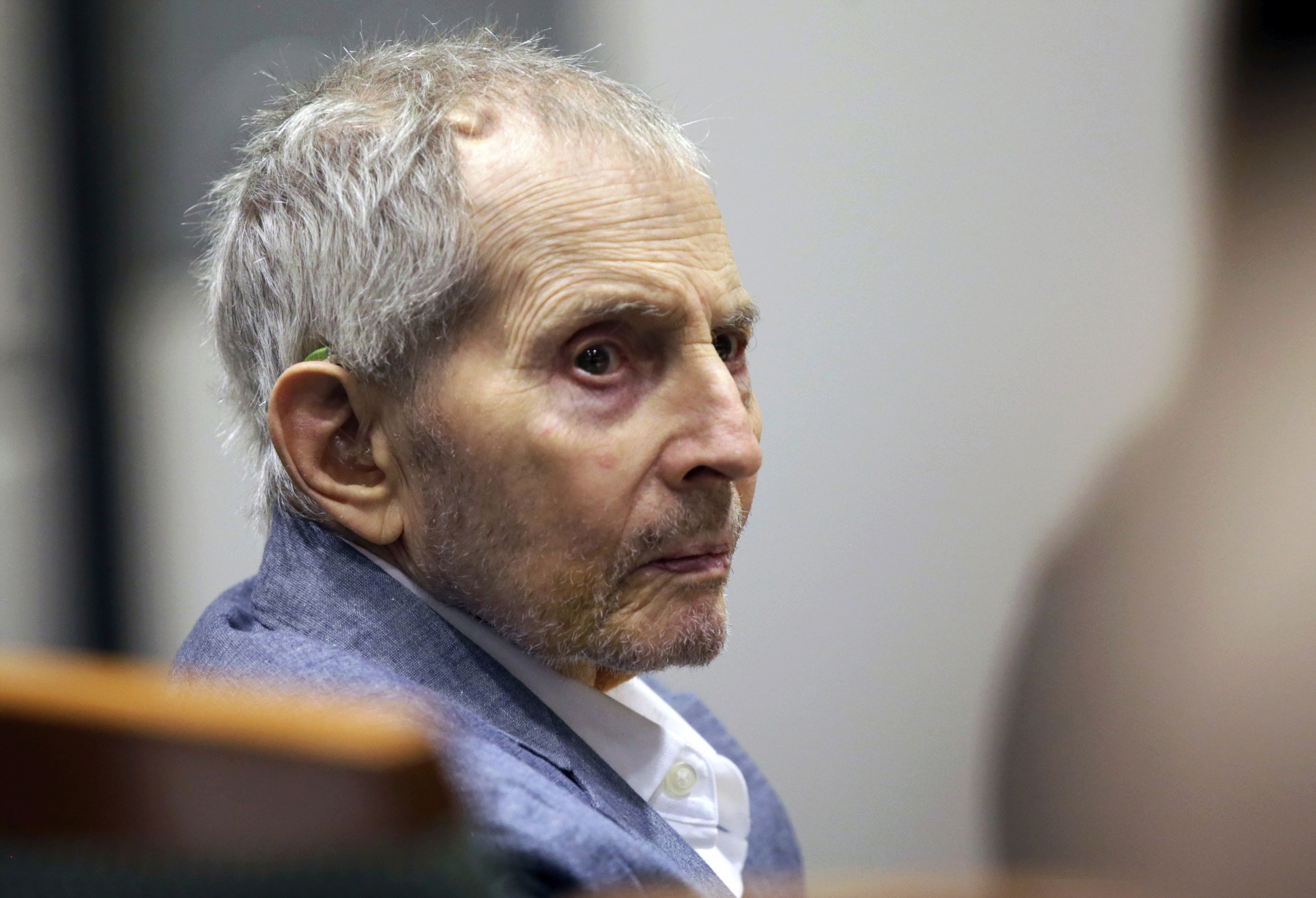 Real estate heir Robert Durst looks over during his murder trial in Los Angeles. 