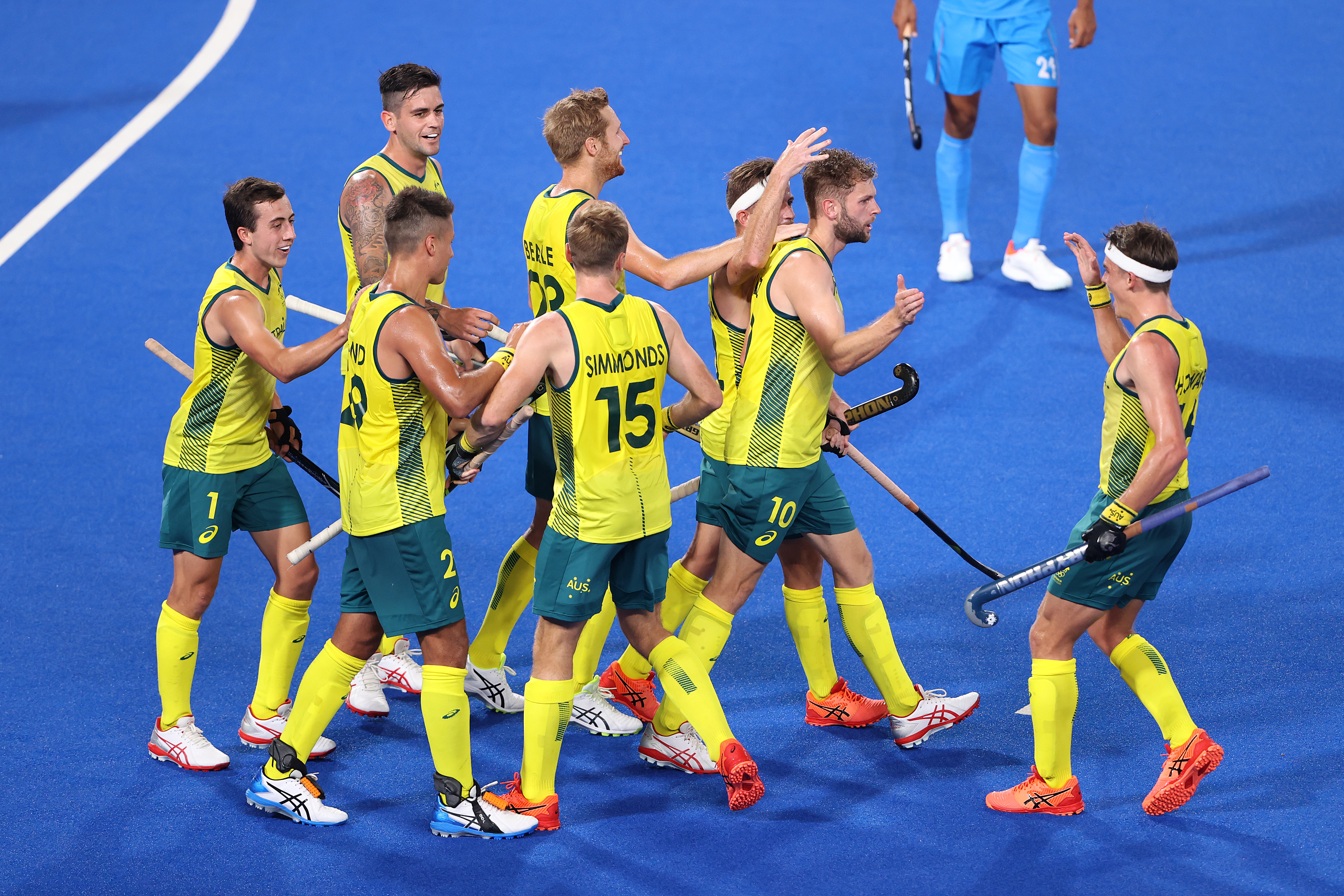 Josh Beltz celebrates with teammates after scoring their team's fourth goal against India.